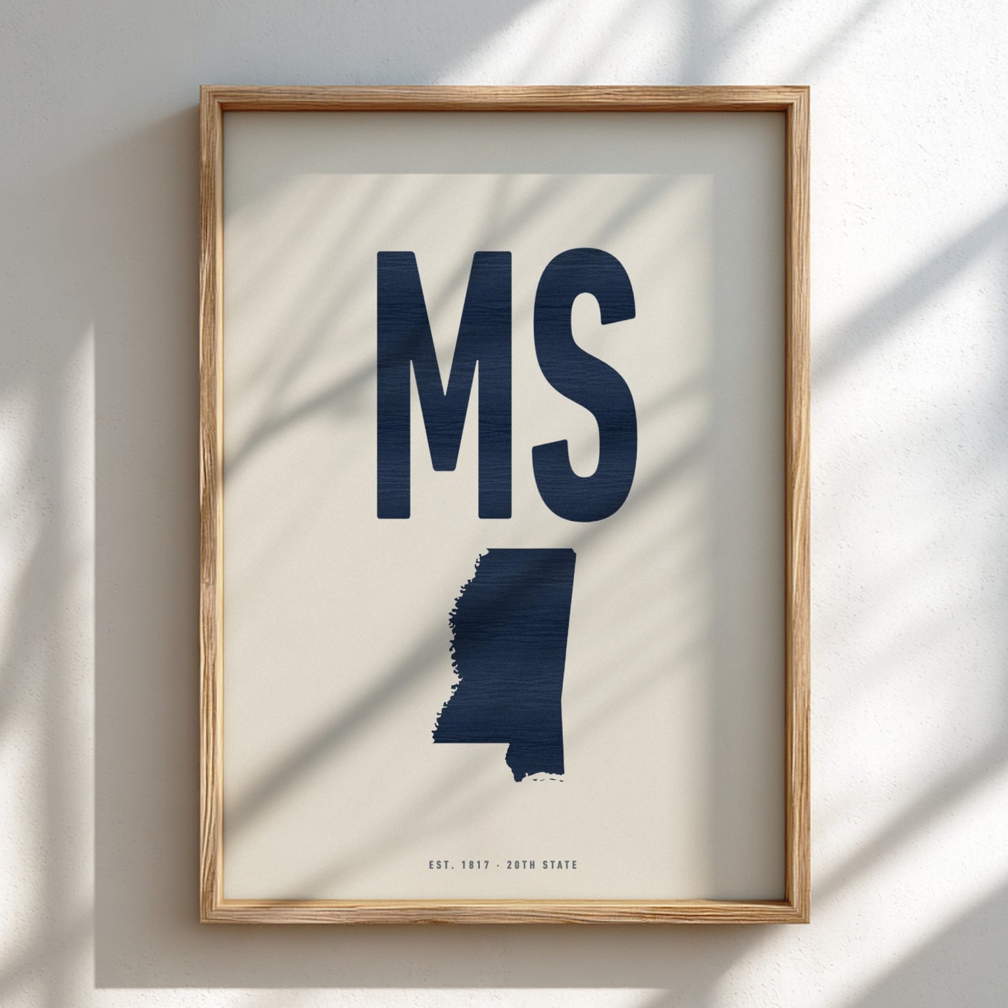 Framed artwork of the state of Mississippi with 'MS' on a light background