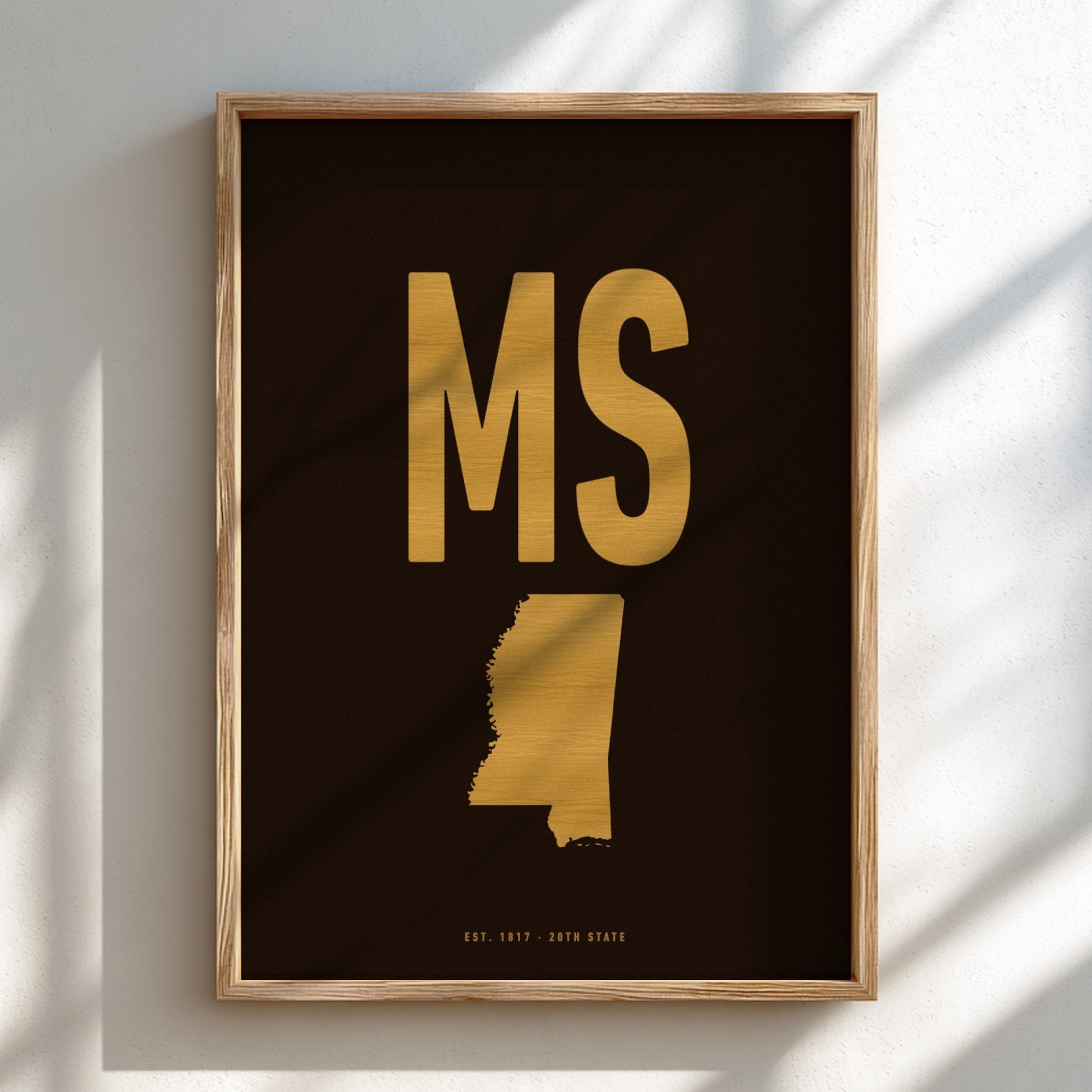 Framed artwork with gold state outline and text on a dark background