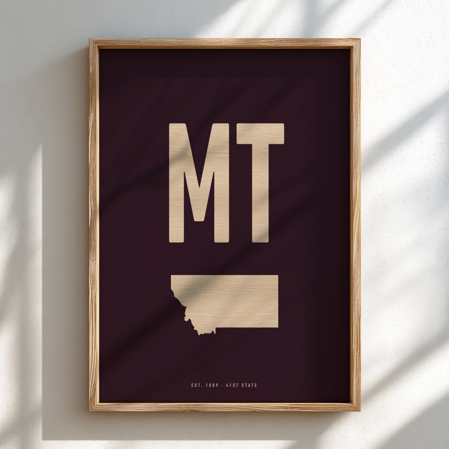 Framed artwork with 'MT' and a map of Montana on a dark background