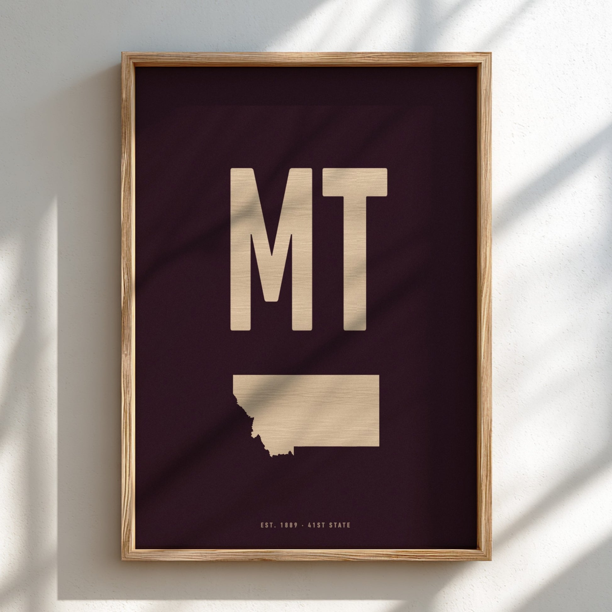 Framed artwork with 'MT' and a map of Montana on a dark background