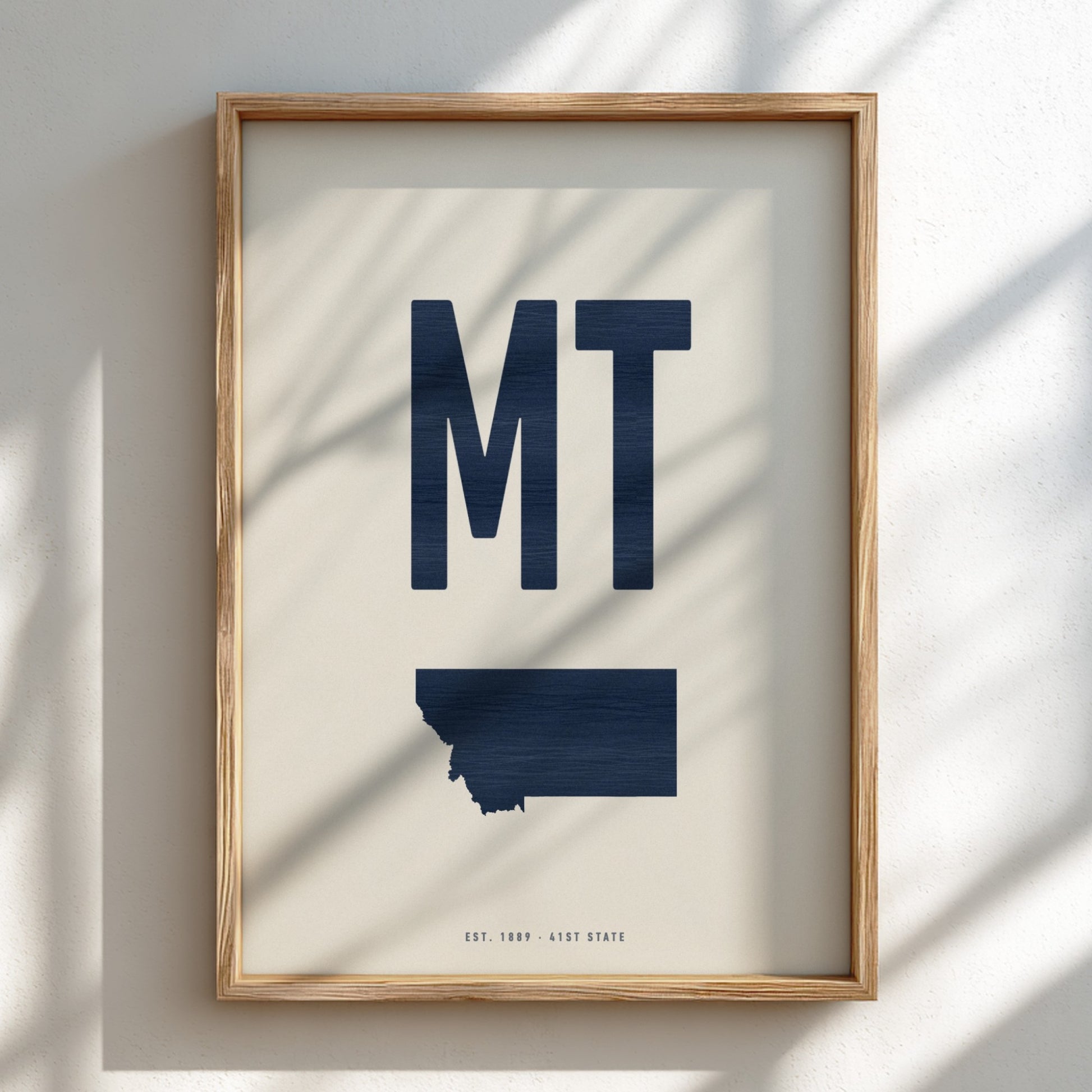 Framed artwork with 'MT' and a map of Montana on a light background