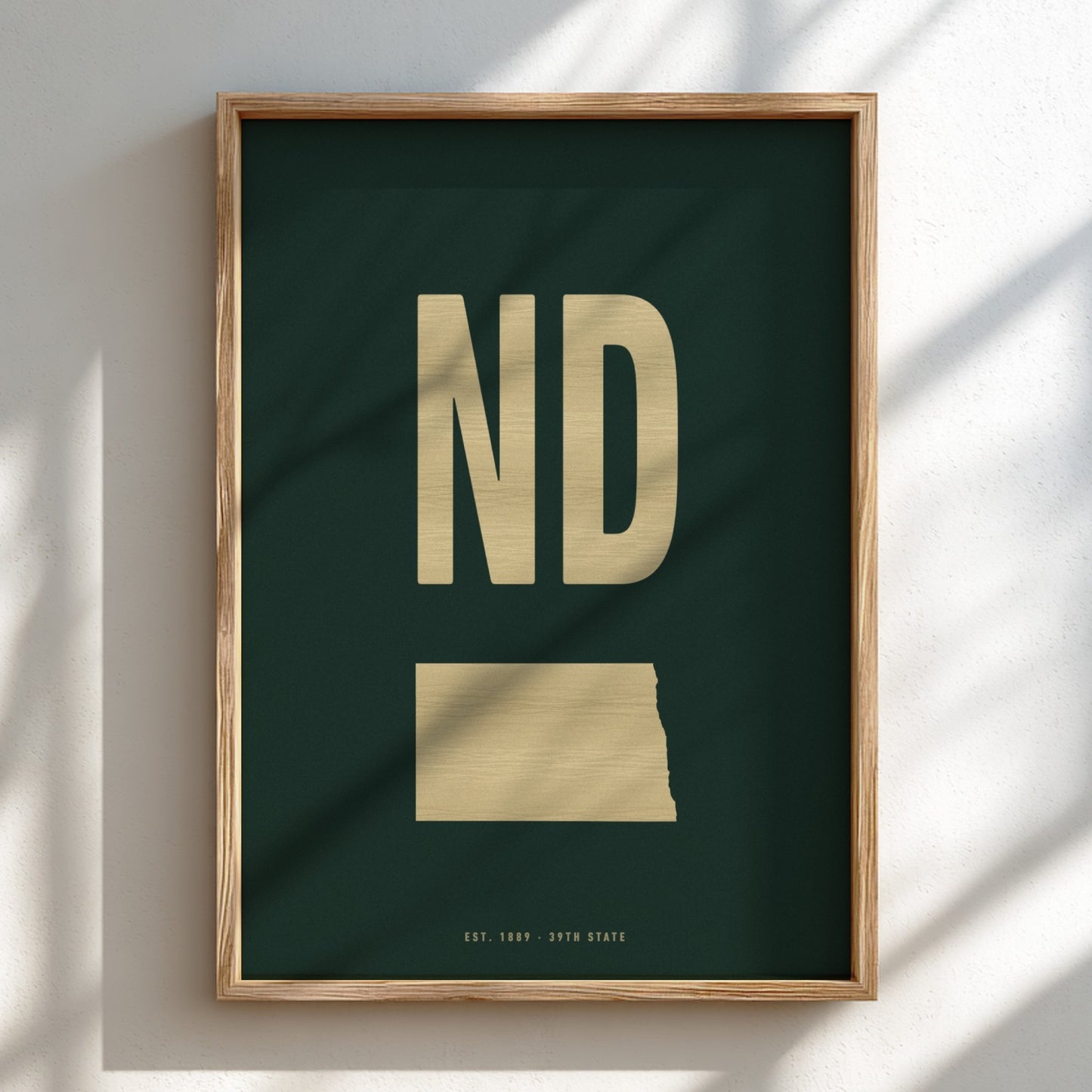 Framed artwork with 'ND' in gold on a dark green background