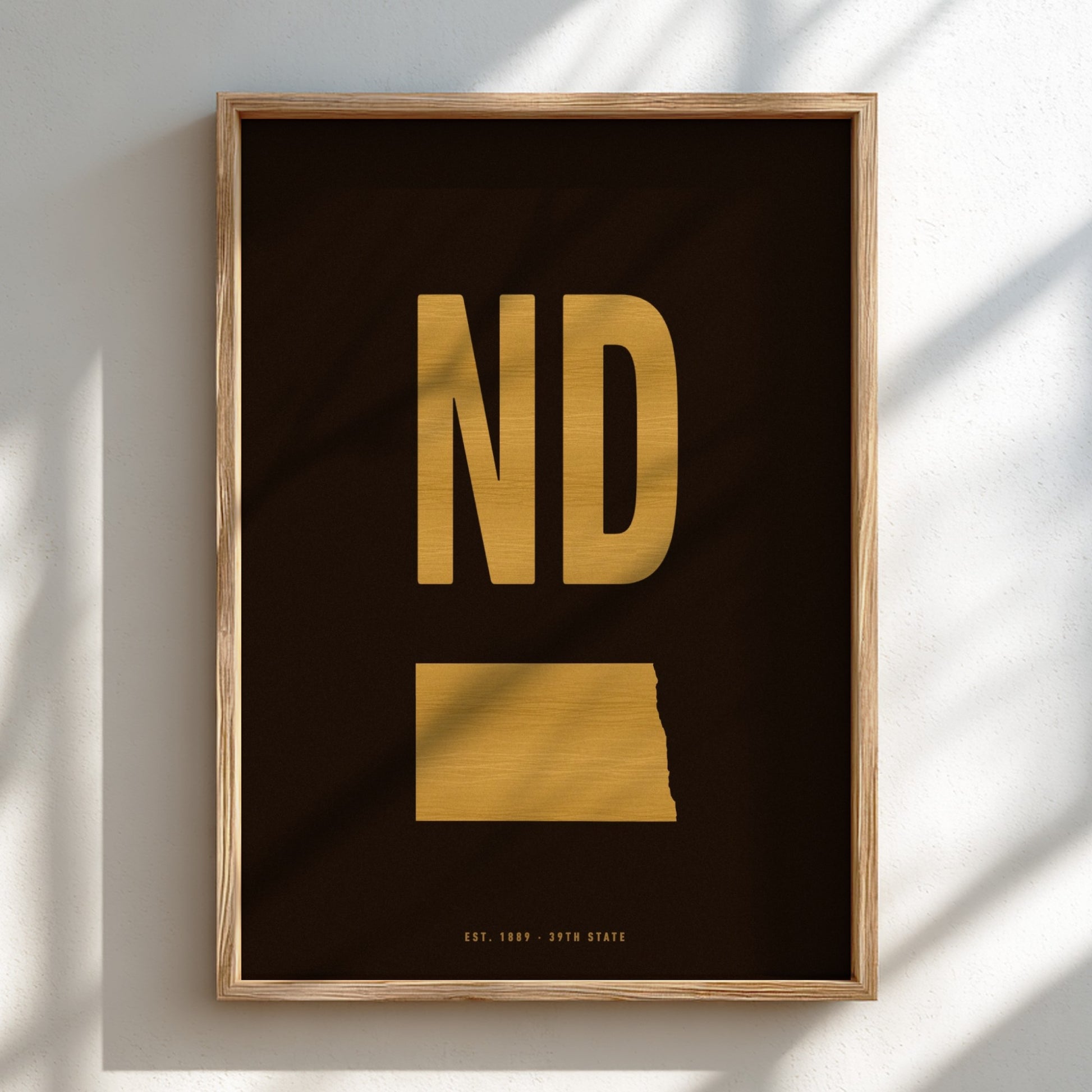 Framed artwork with 'ND' in gold on a black background