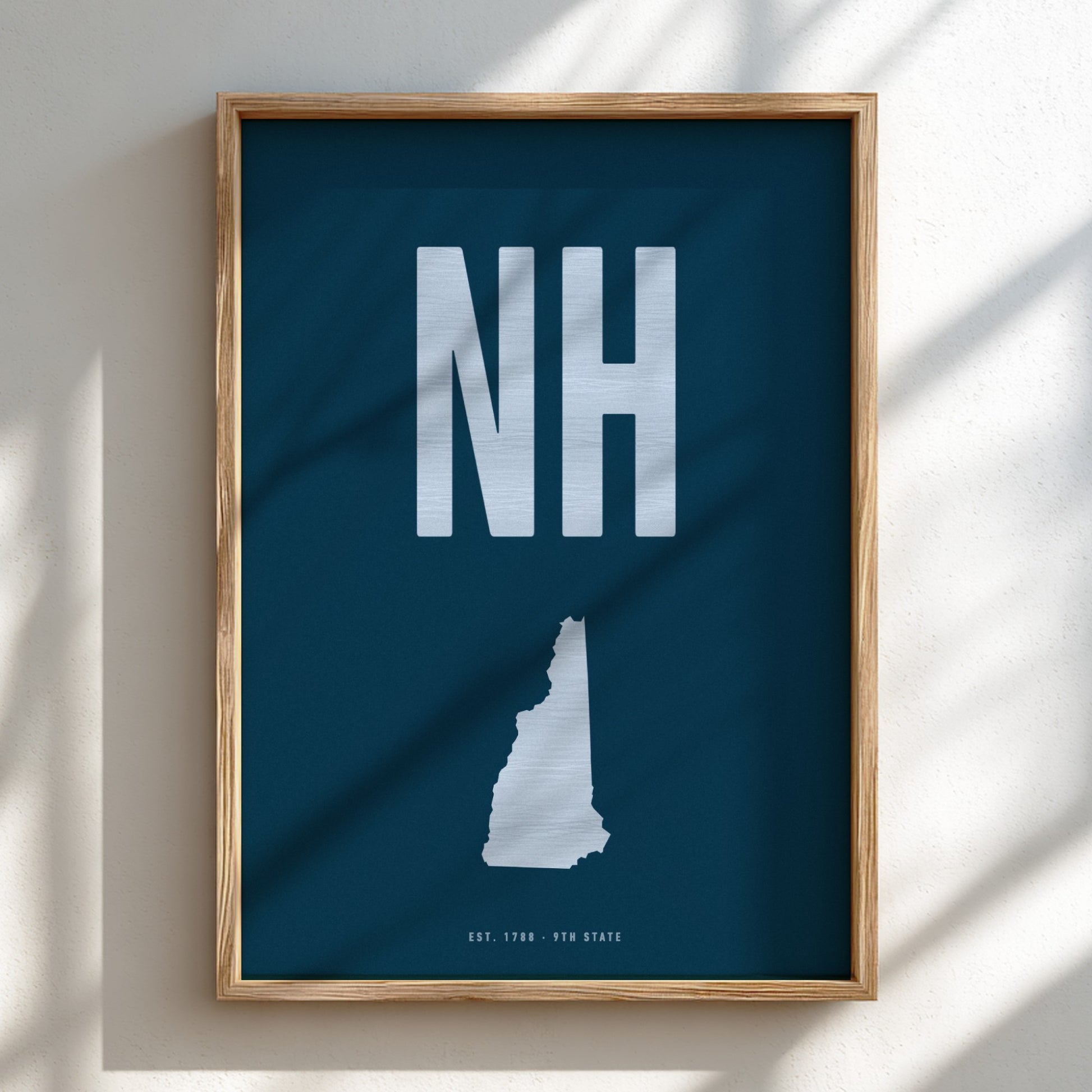 Framed poster with 'NH' on a blue background
