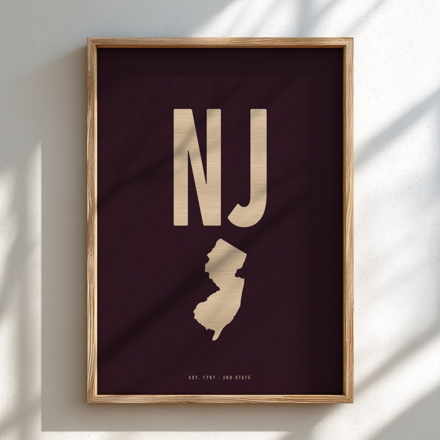 Framed poster with 'NJ' and outline of New Jersey on a dark background