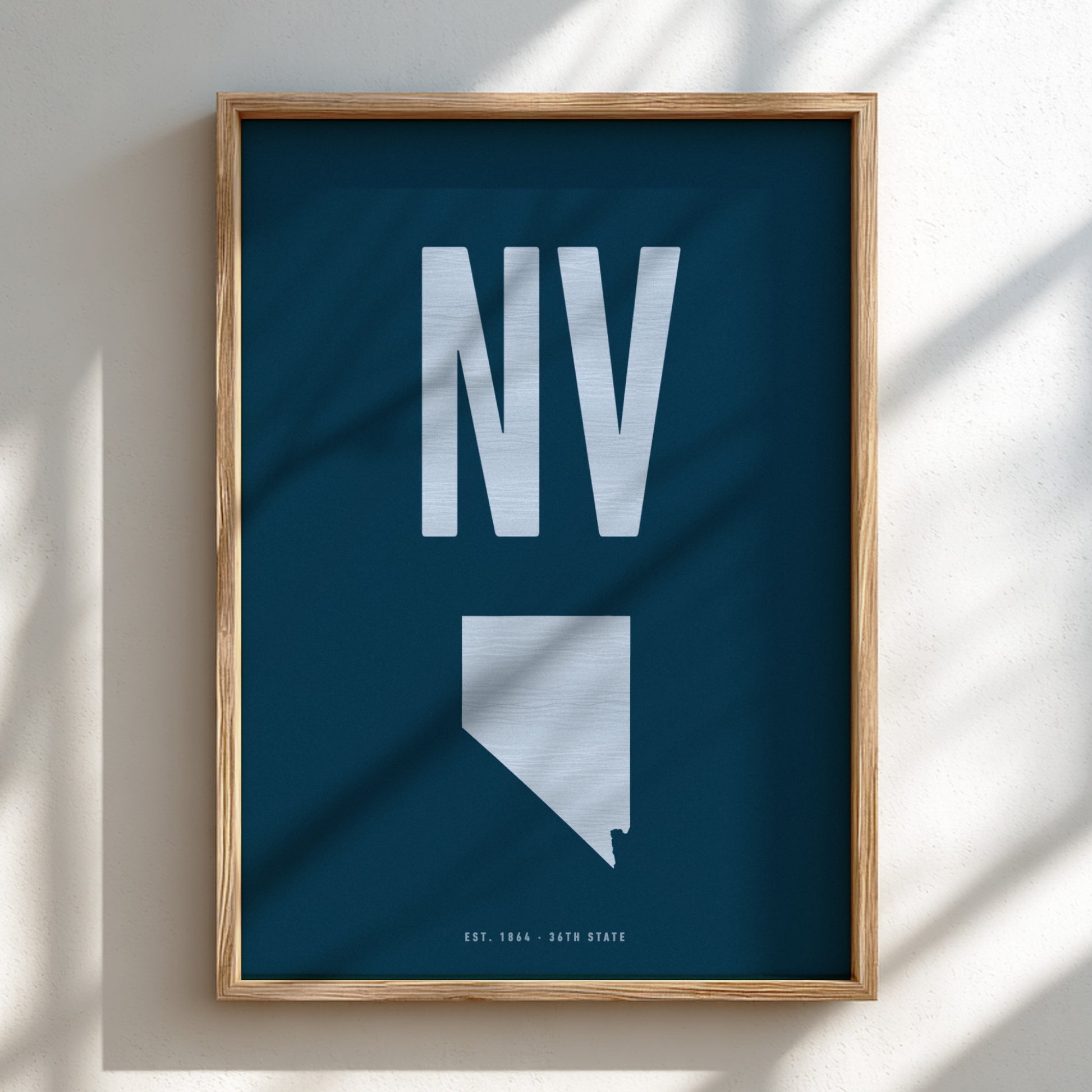 Framed poster with 'NV' and outline of Nevada on a blue background