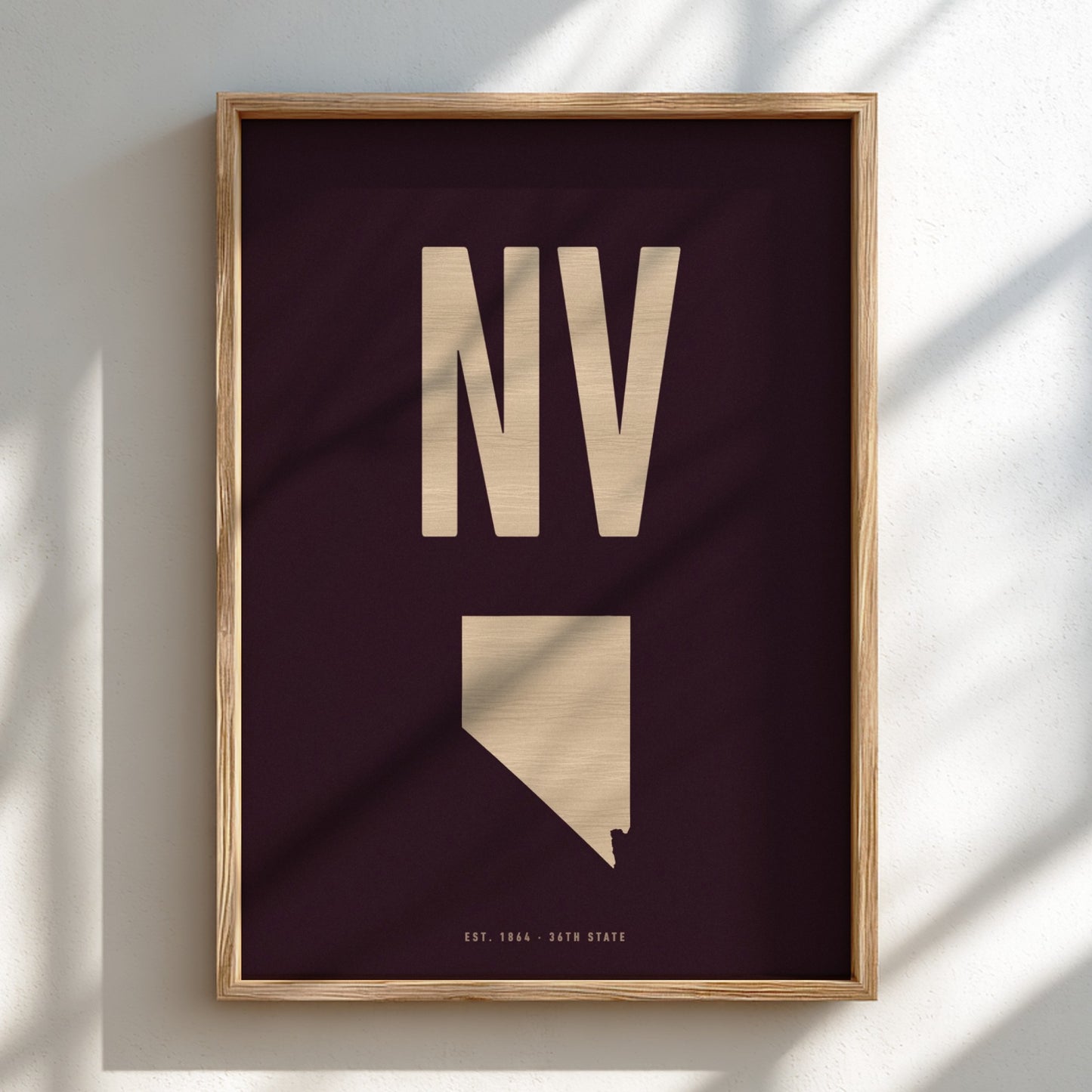 Framed artwork with 'NV' and a map of Nevada on a dark background