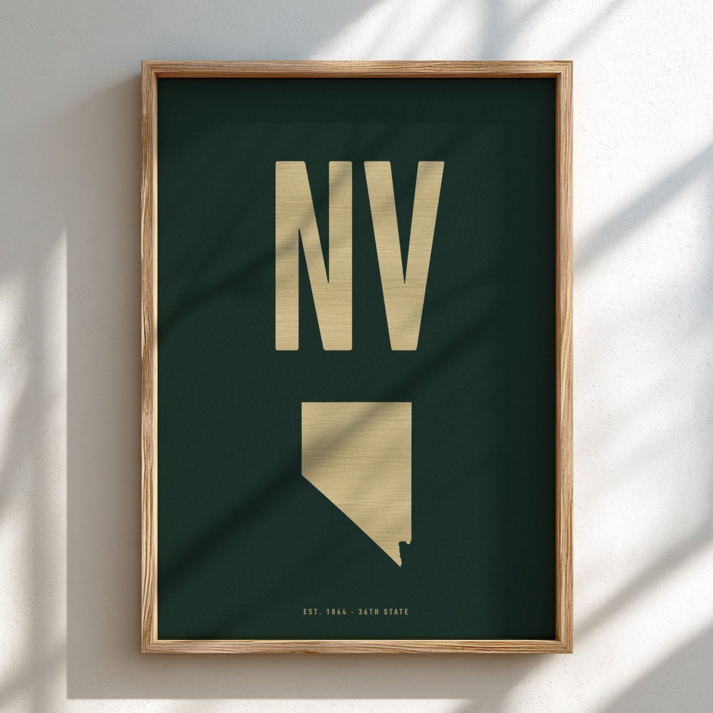 Framed poster with 'NV' and a map of Nevada on a dark green background