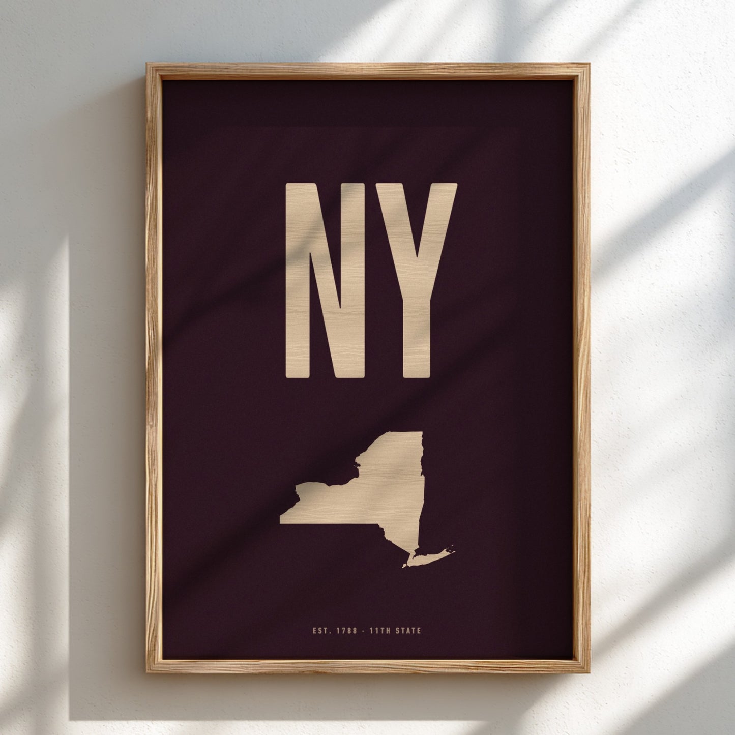 Framed poster with 'NY' and state outline on a dark background