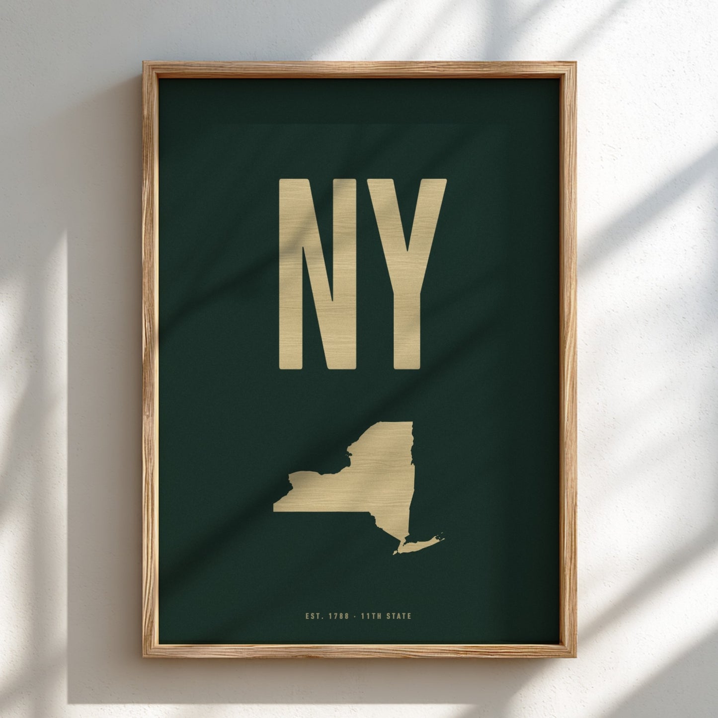 Framed artwork with 'NY' in gold on a dark green background