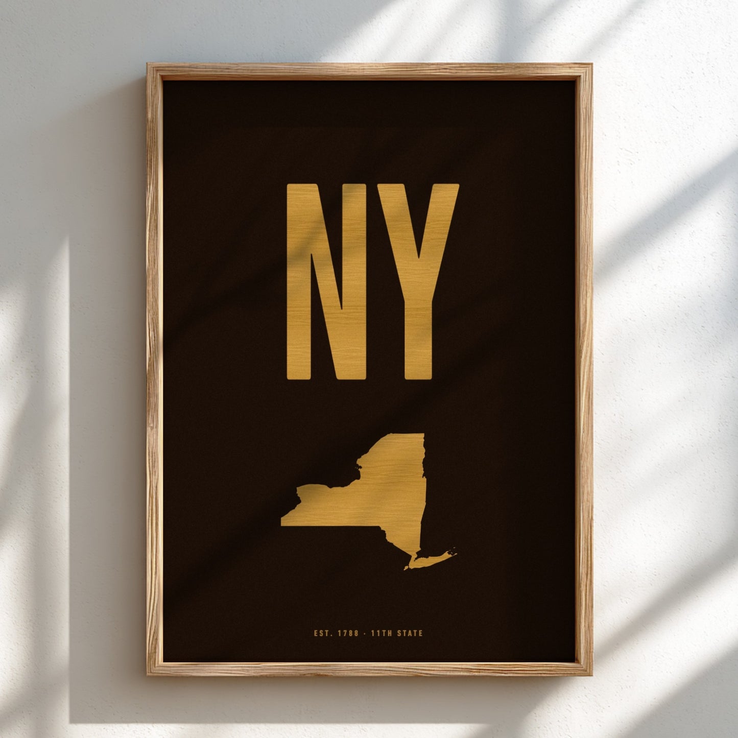 Framed artwork with 'NY' in gold on a black background