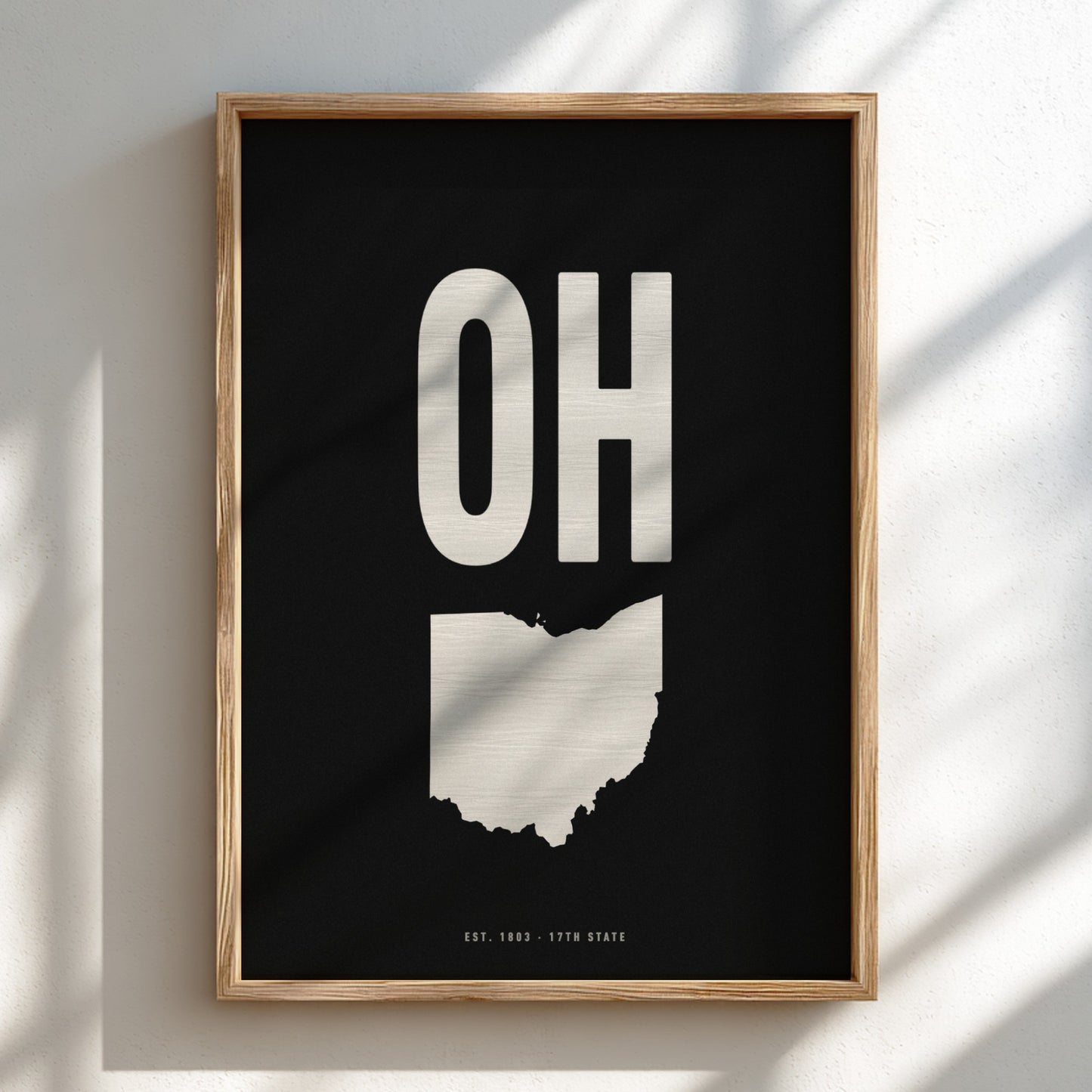 Framed artwork with 'OH' and state outline on a black background