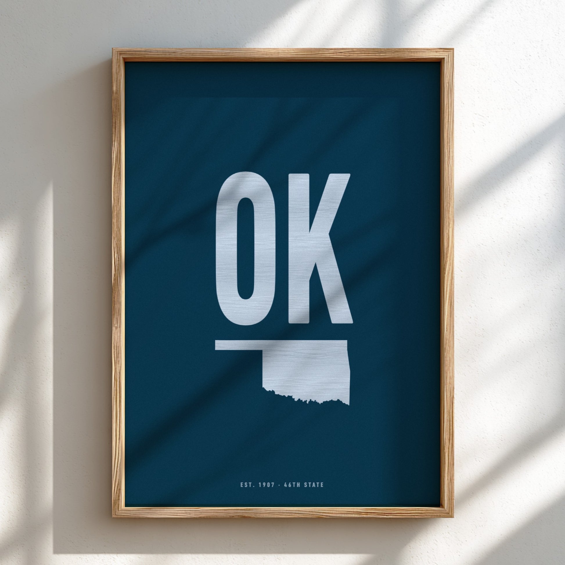 Framed poster with 'OK' and outline of Oklahoma on a blue background