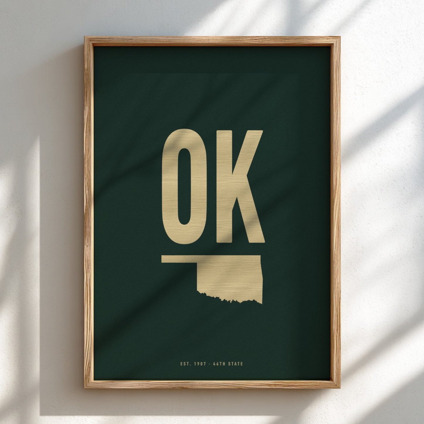 Framed artwork with 'OK' in gold on a dark green background