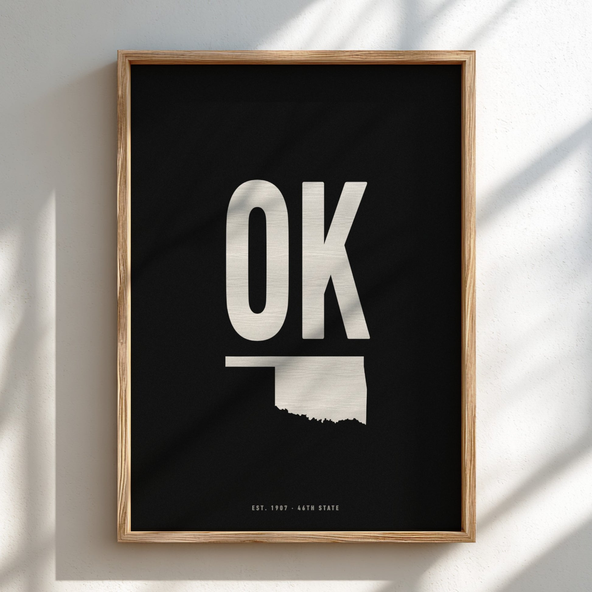 Framed poster with 'OK' and outline of Oklahoma on a black background