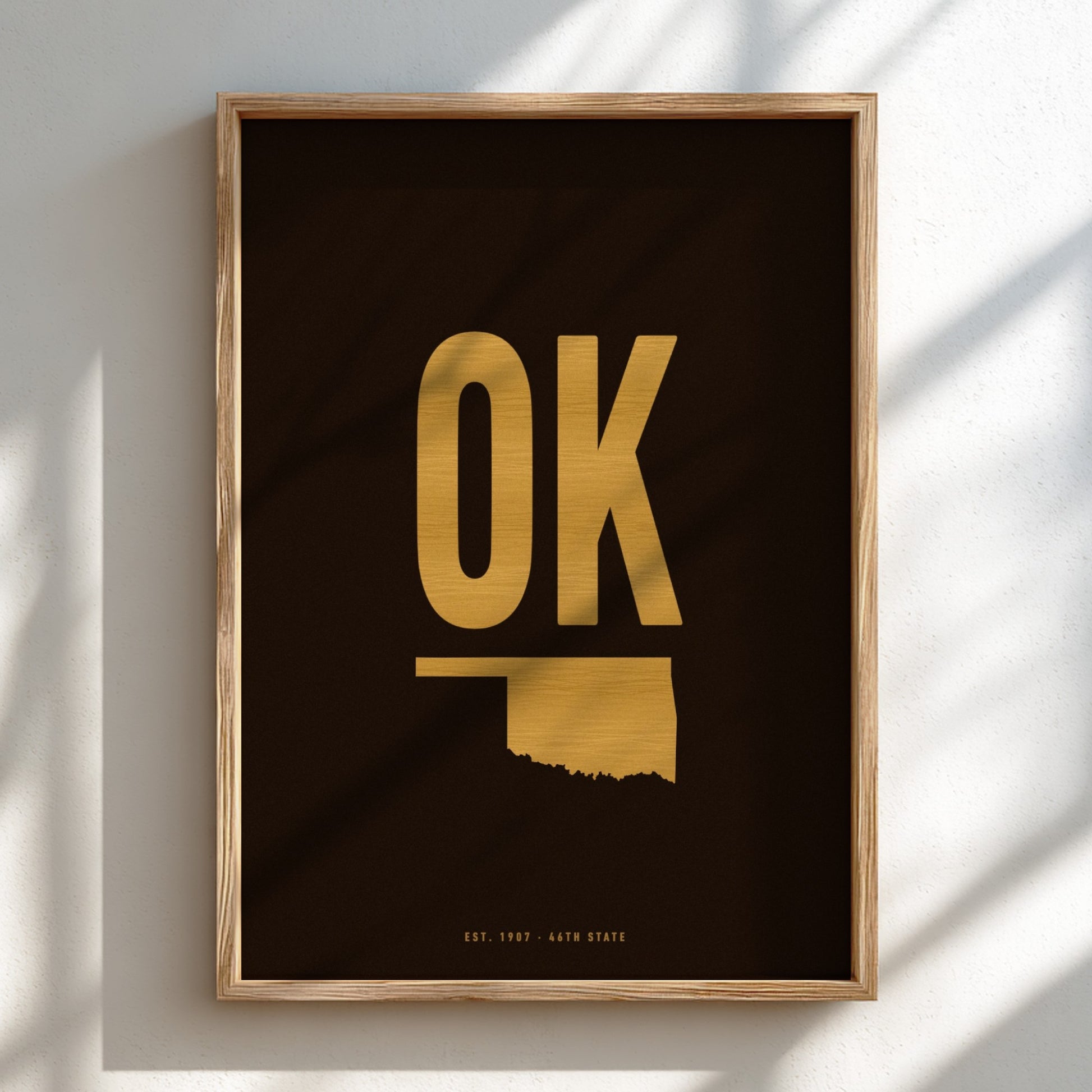 Framed artwork with 'OK' in gold on a black background
