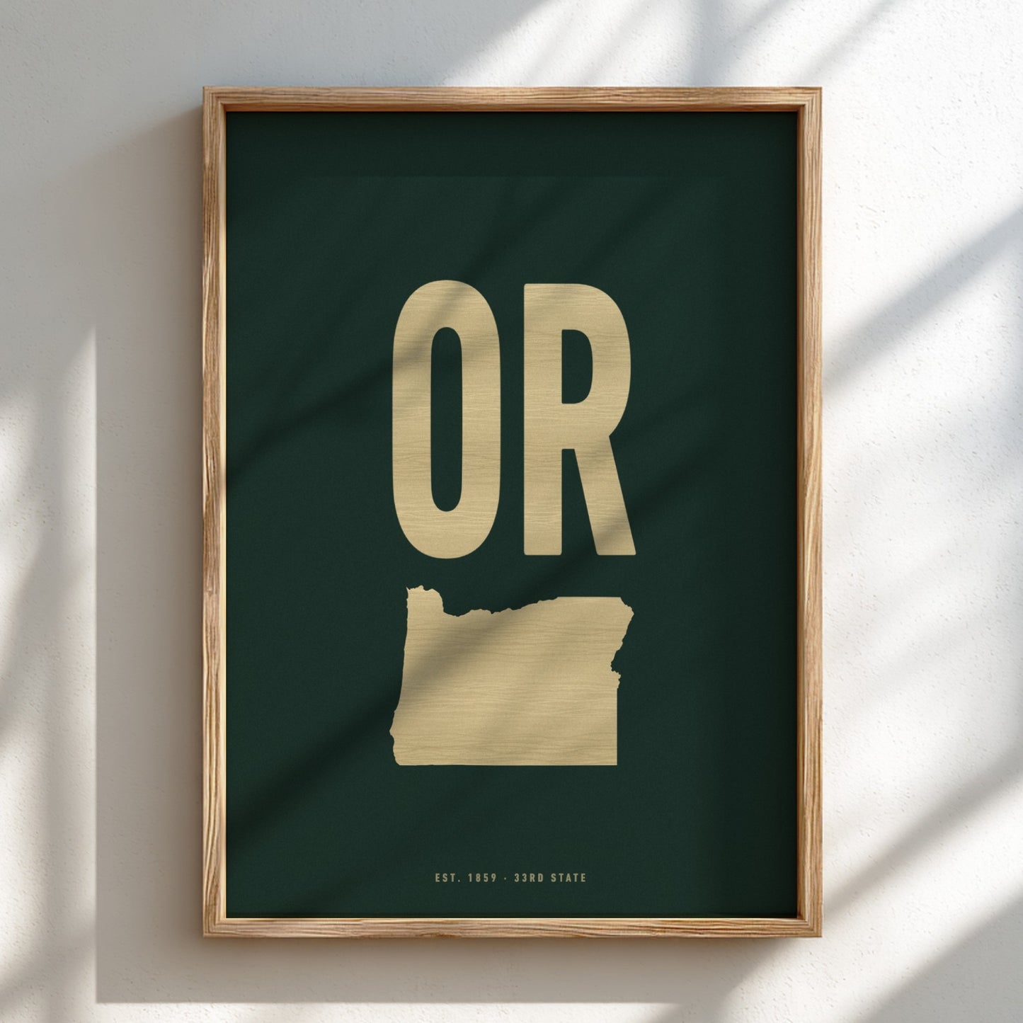 Framed artwork with 'OR' in gold on a dark green background