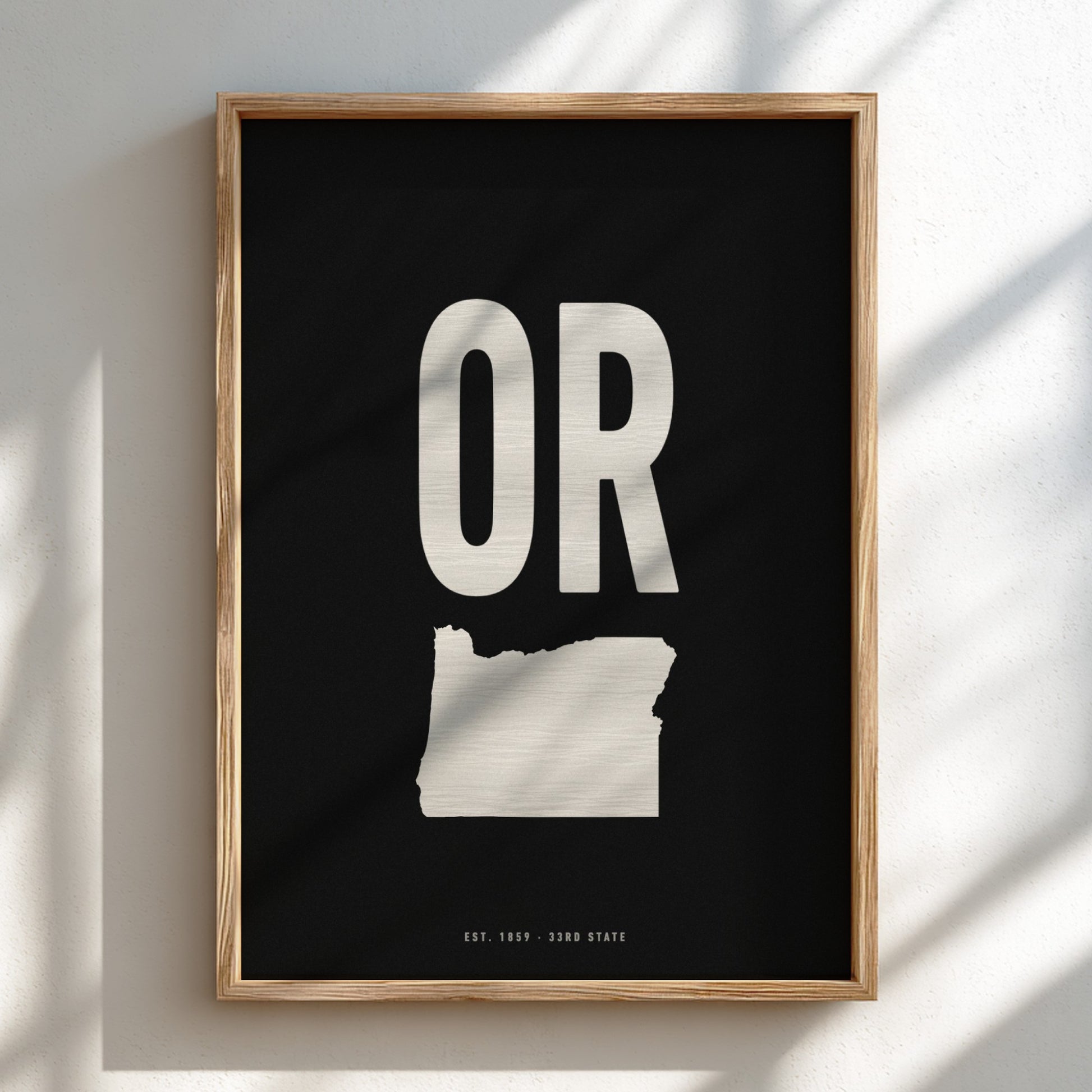 Framed poster with 'OR' and outline of Oregon on a black background
