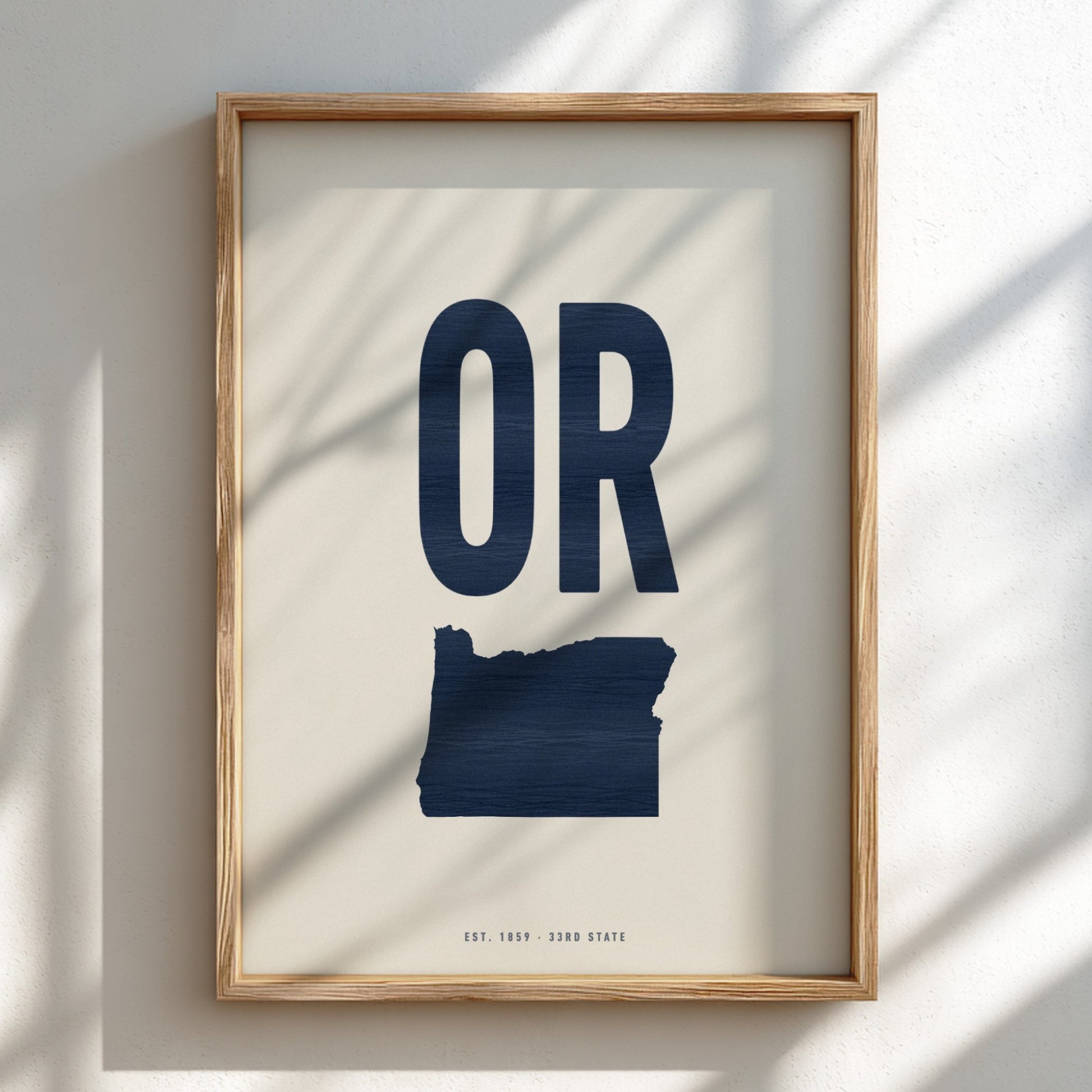 Framed artwork with 'OR' and outline of Oregon on a light background