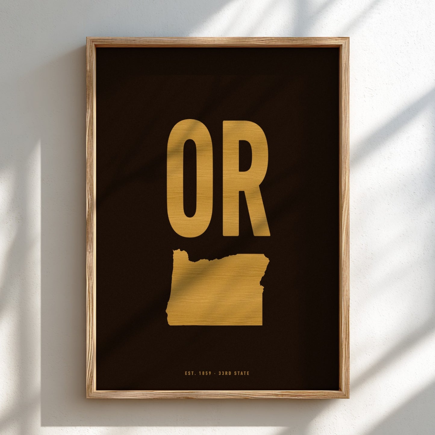 Framed artwork with gold 'OR' on a black background