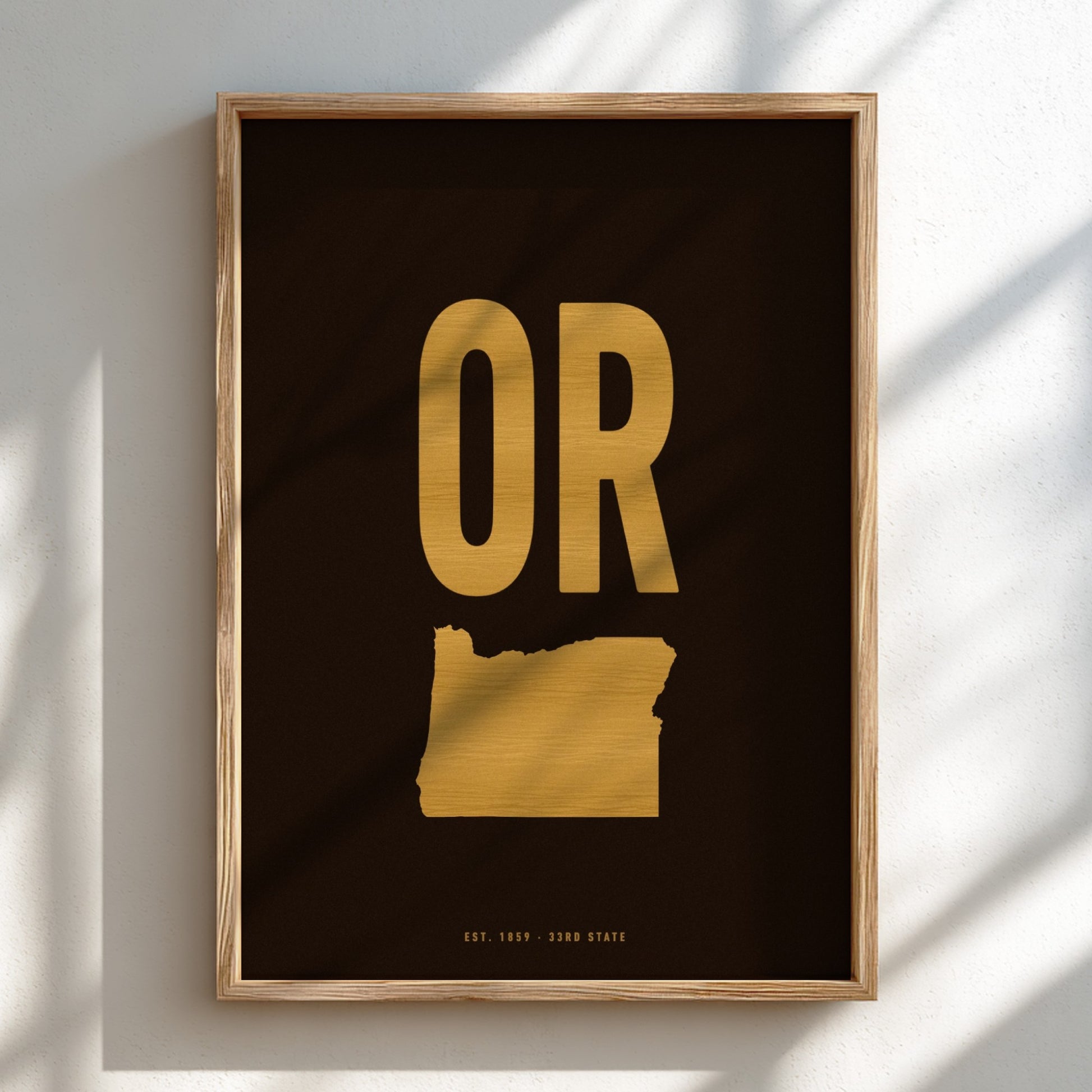 Framed artwork with gold 'OR' on a black background