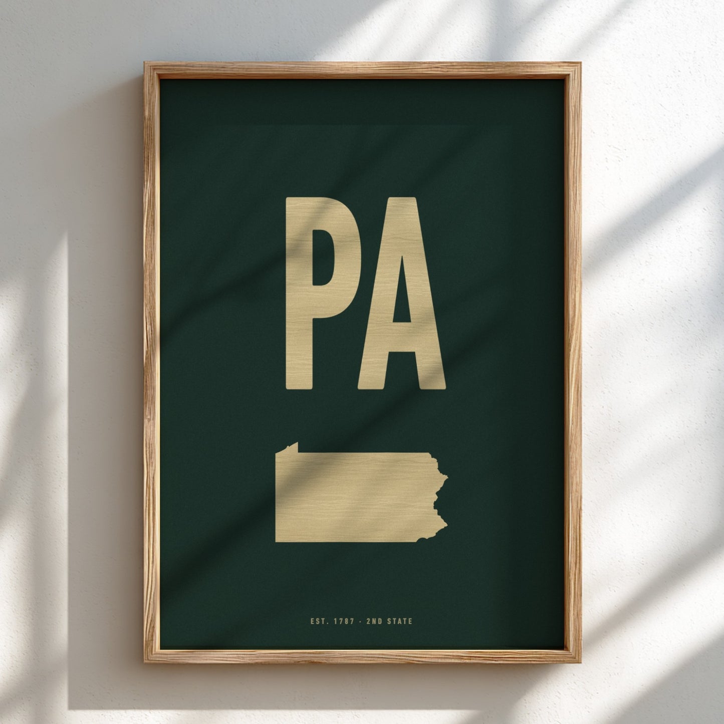 Framed artwork with 'PA' on a dark green background