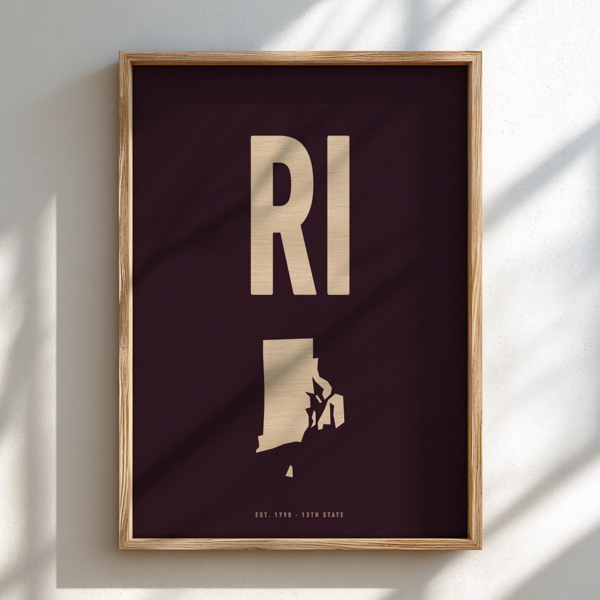 Framed poster with 'RI' and silhouette of Rhode Island on a dark background