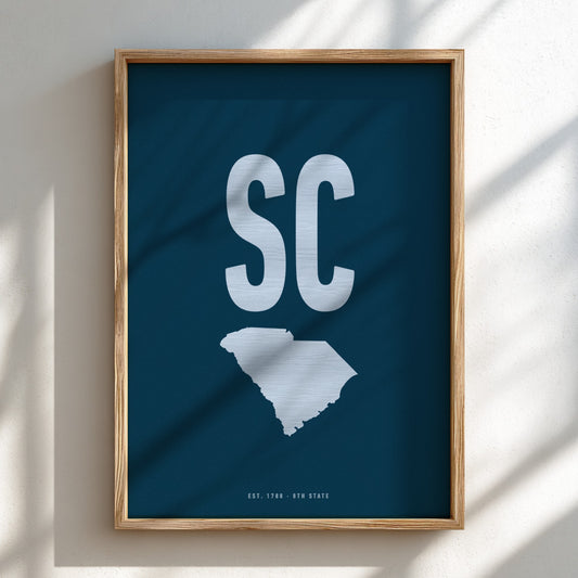 Framed artwork with 'SC' and a map of South Carolina on a blue background
