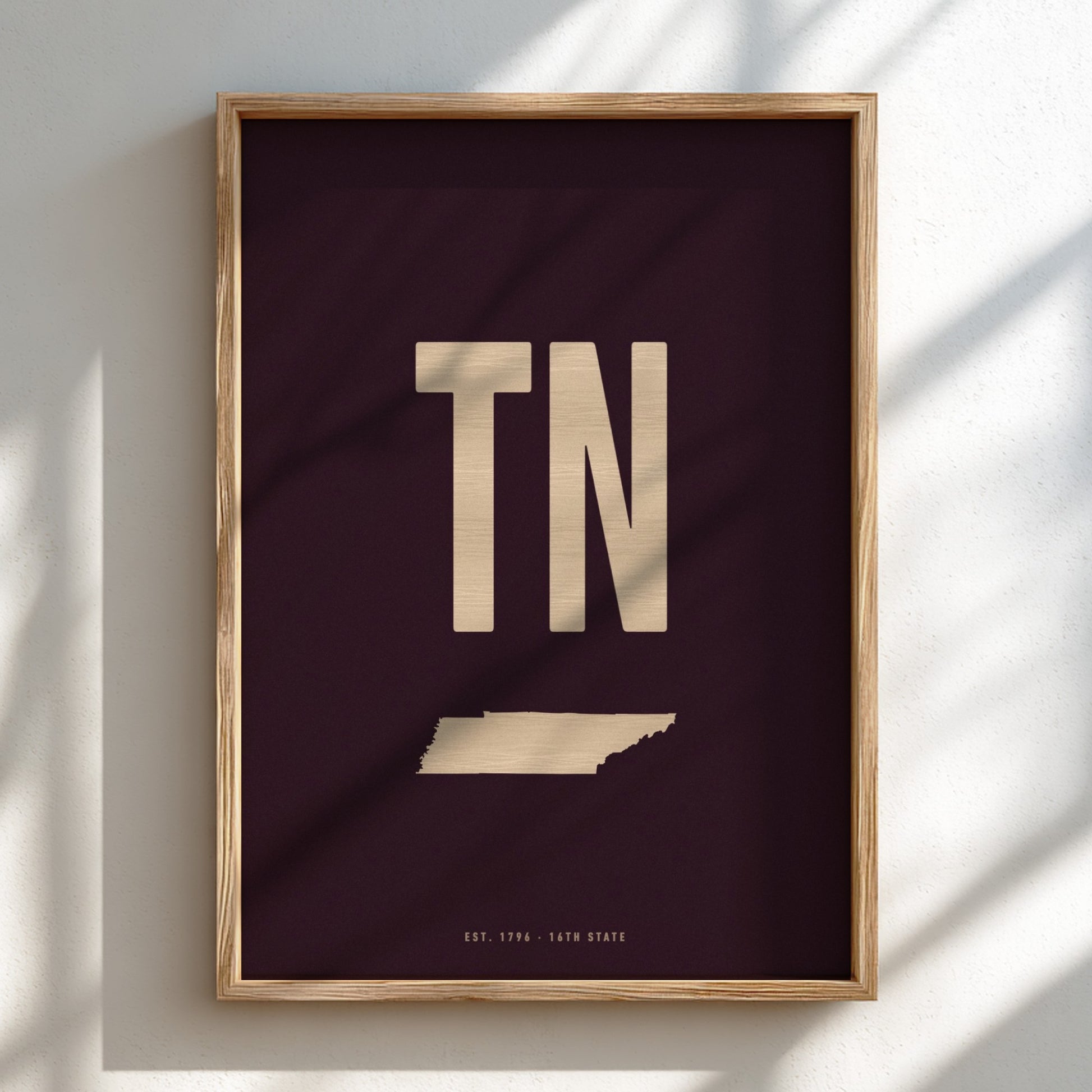 Framed artwork with 'TN' and a map of Tennessee on a dark background