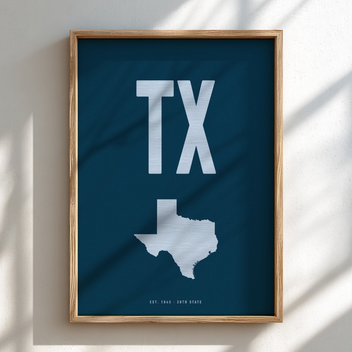 Framed poster with 'TX' and a map of Texas on a blue background