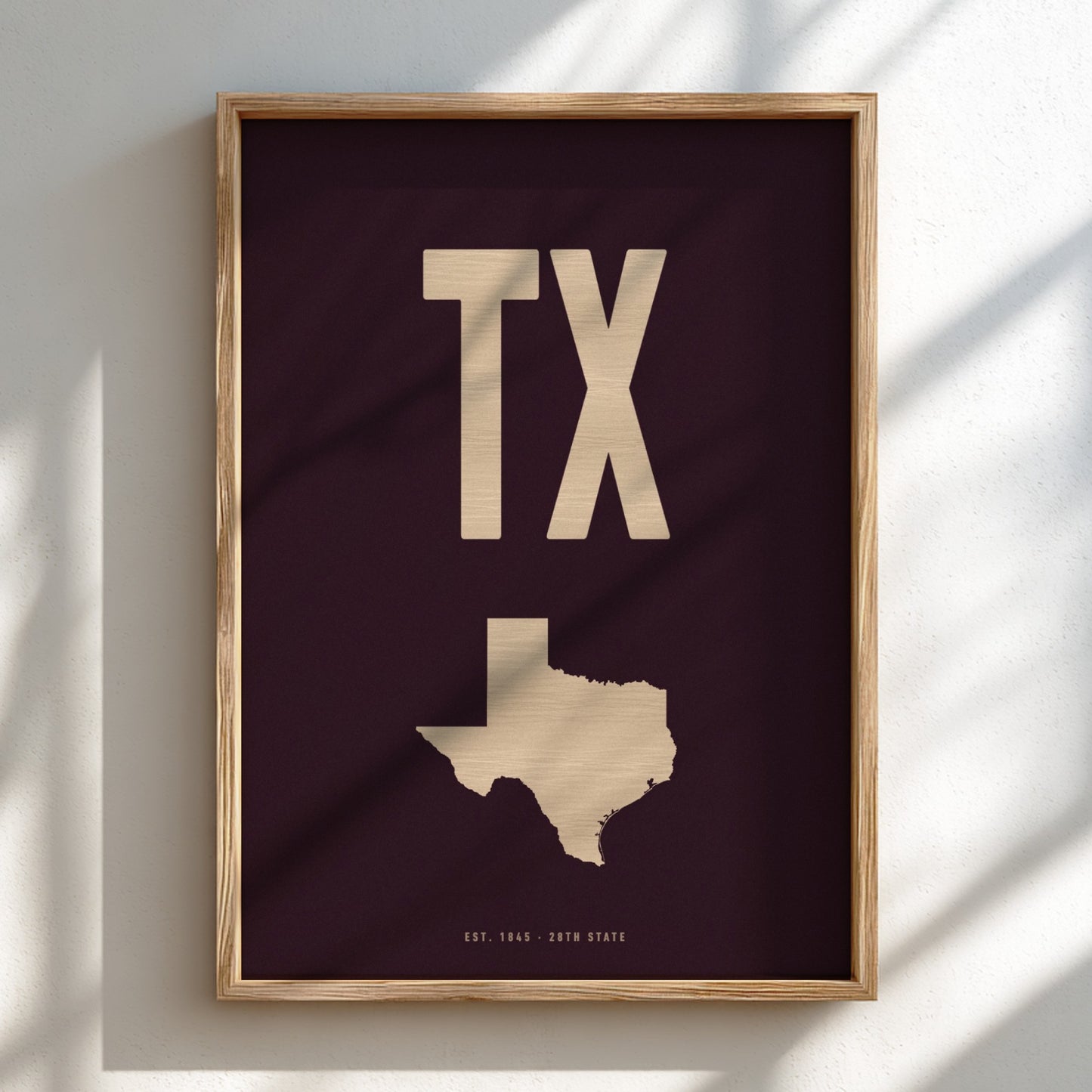 Framed artwork with 'TX' and a map of Texas on a dark background