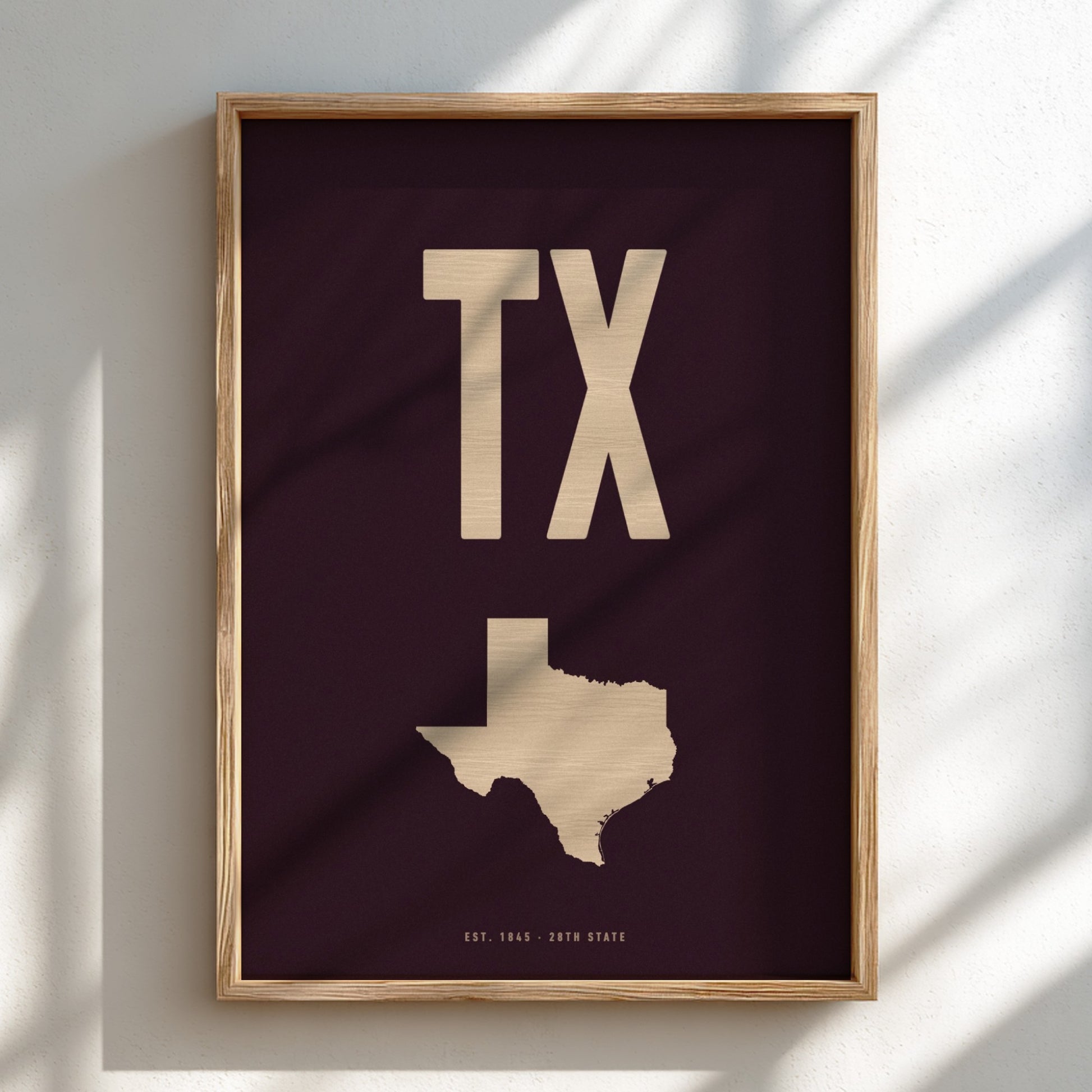 Framed artwork with 'TX' and a map of Texas on a dark background