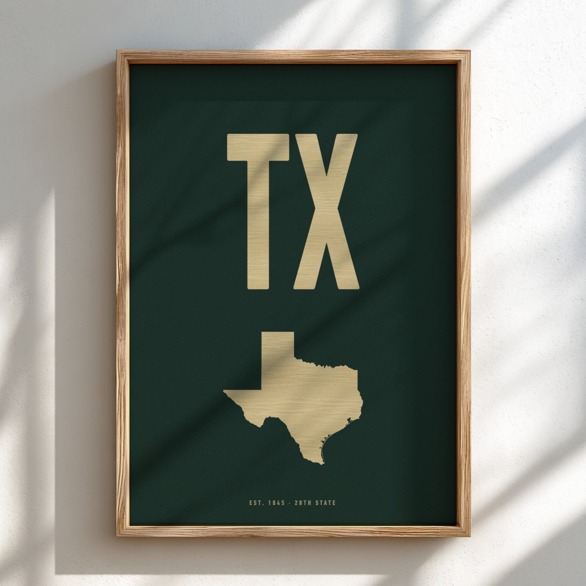 Framed artwork with 'TX' and a map of Texas on a dark green background