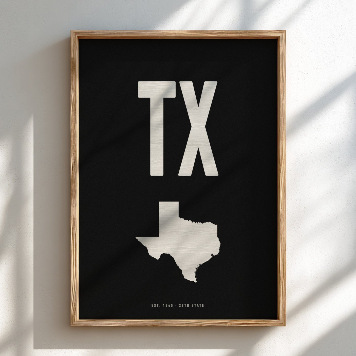 Framed poster with 'TX' and a map of Texas on a black background