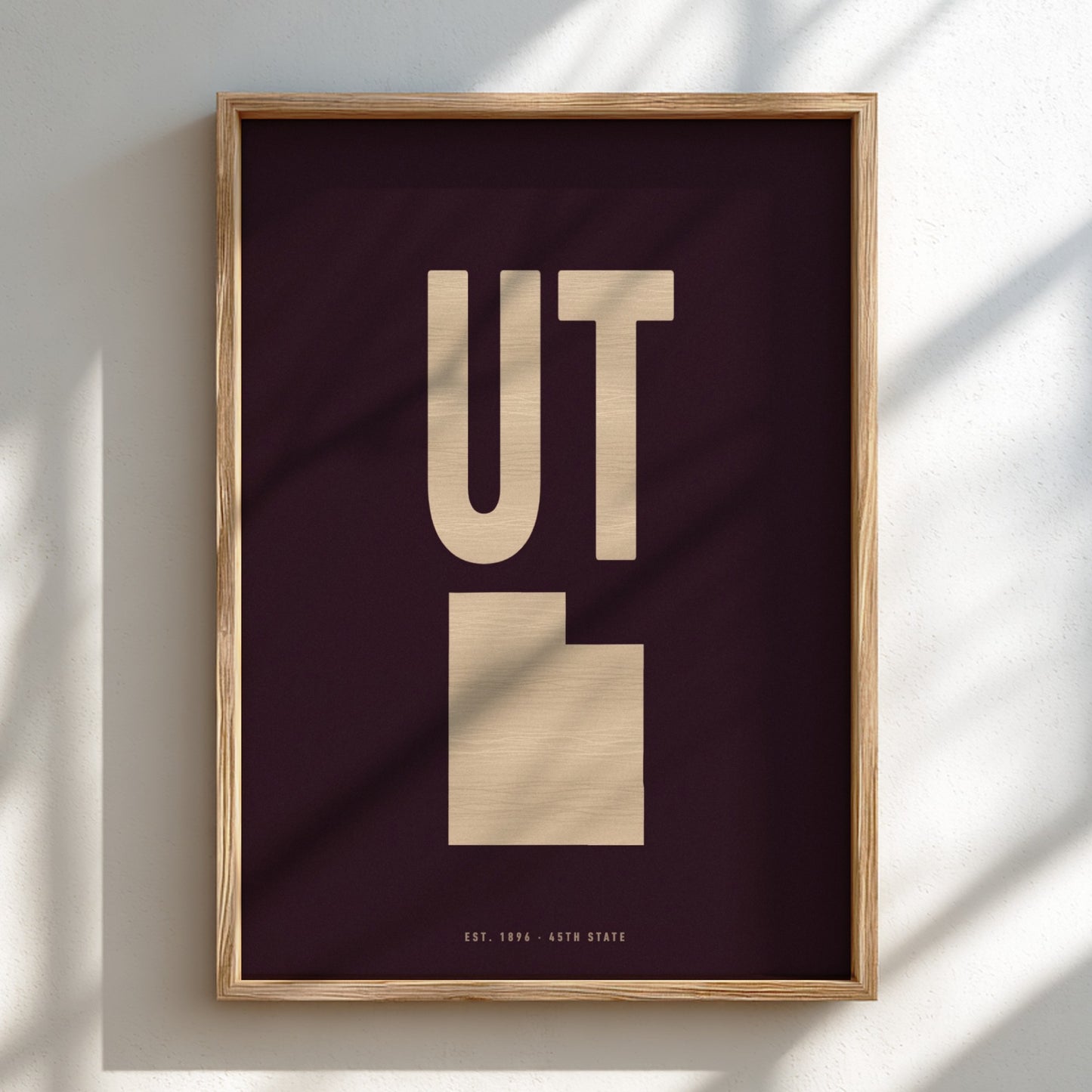 Framed poster with 'UT' on a dark background