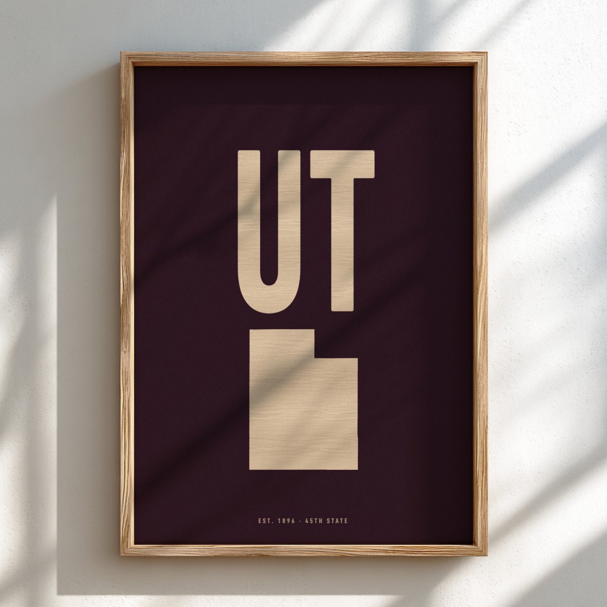 Framed poster with 'UT' on a dark background