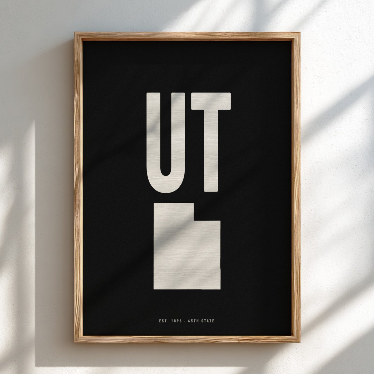 Framed poster with 'UT' design on a black background