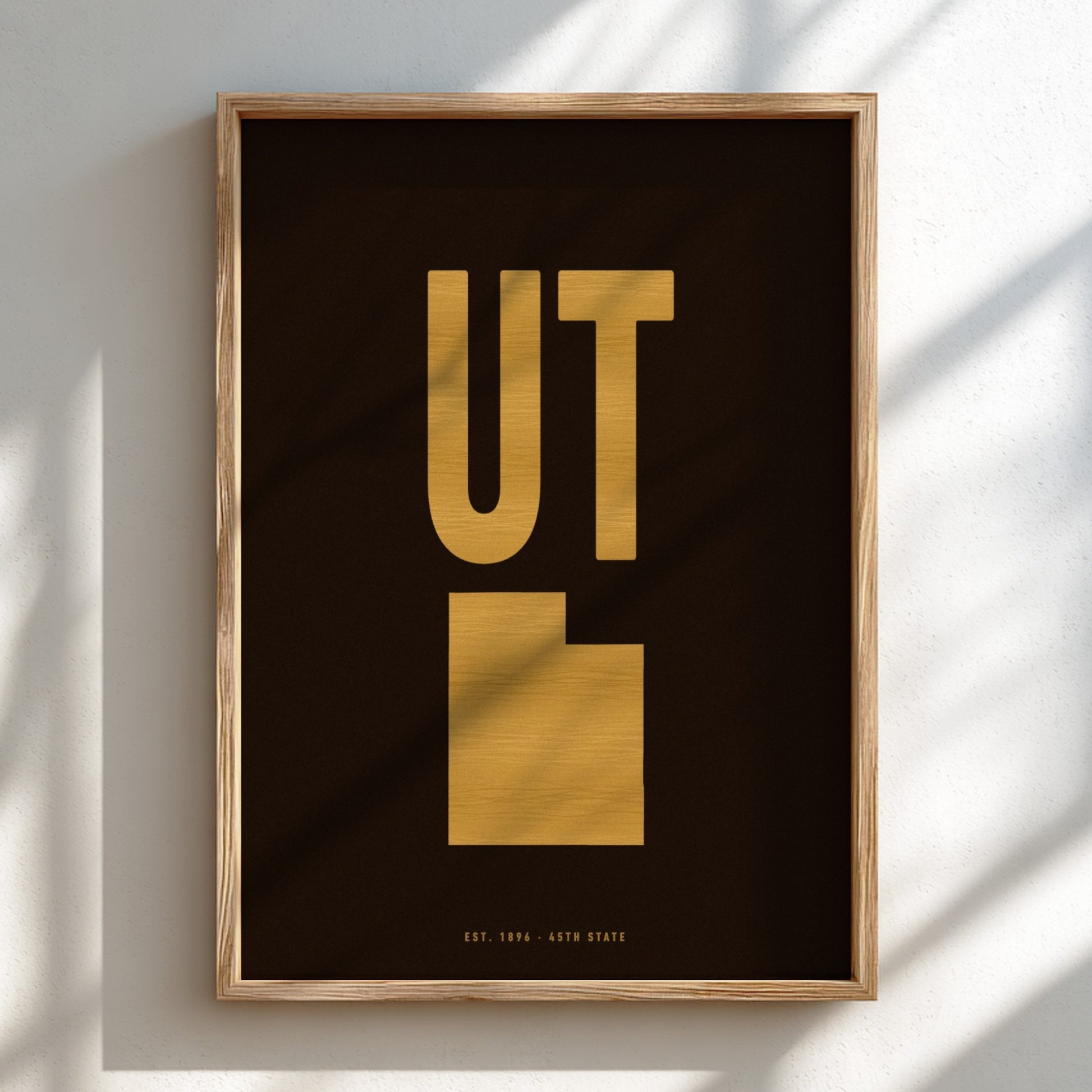 Framed artwork with 'UT' in gold on a dark background