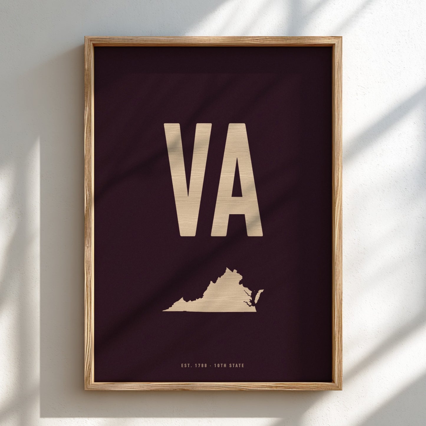 Framed poster with 'VA' initials and a map of Virginia on a dark background