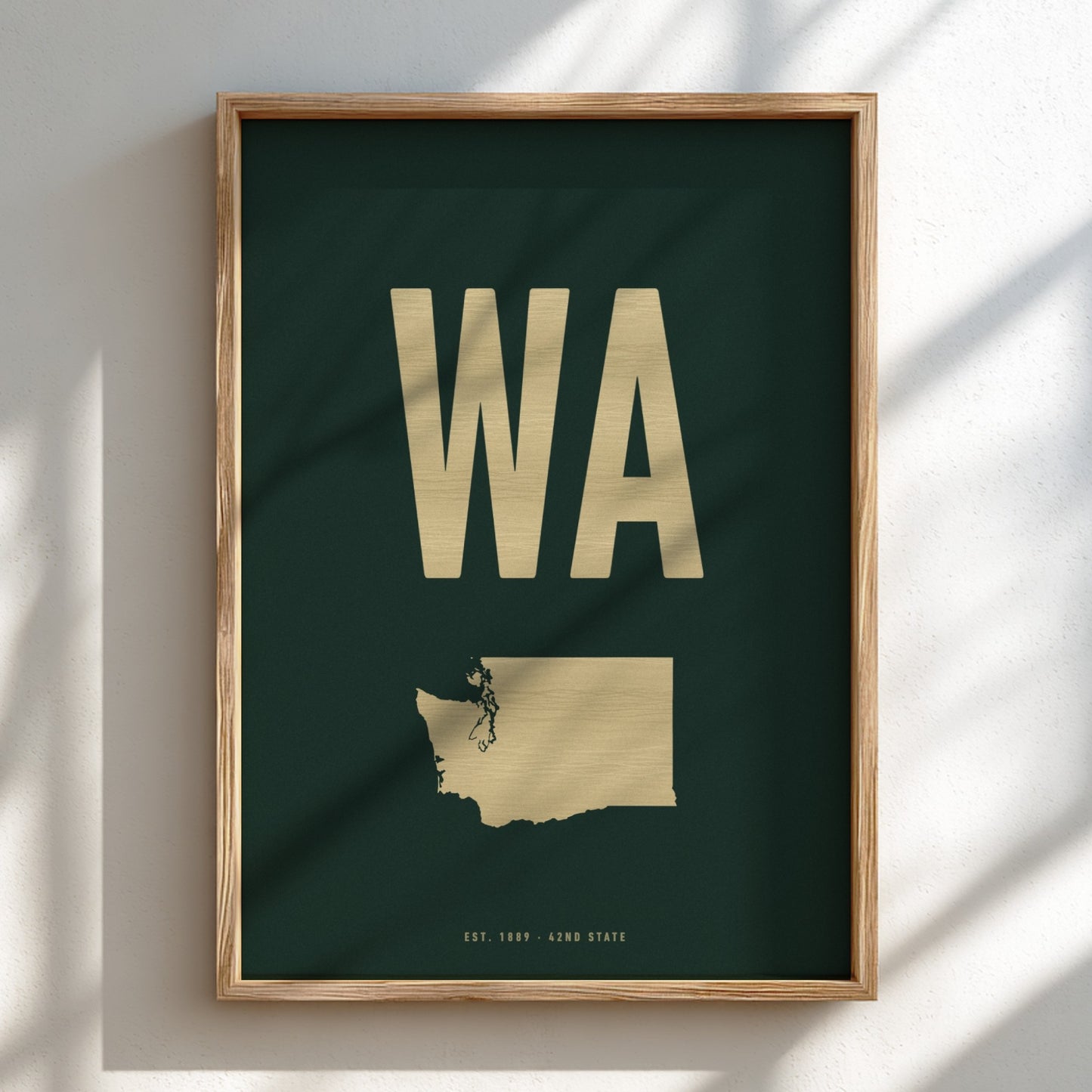 Framed poster with 'WA' in gold on a dark green background