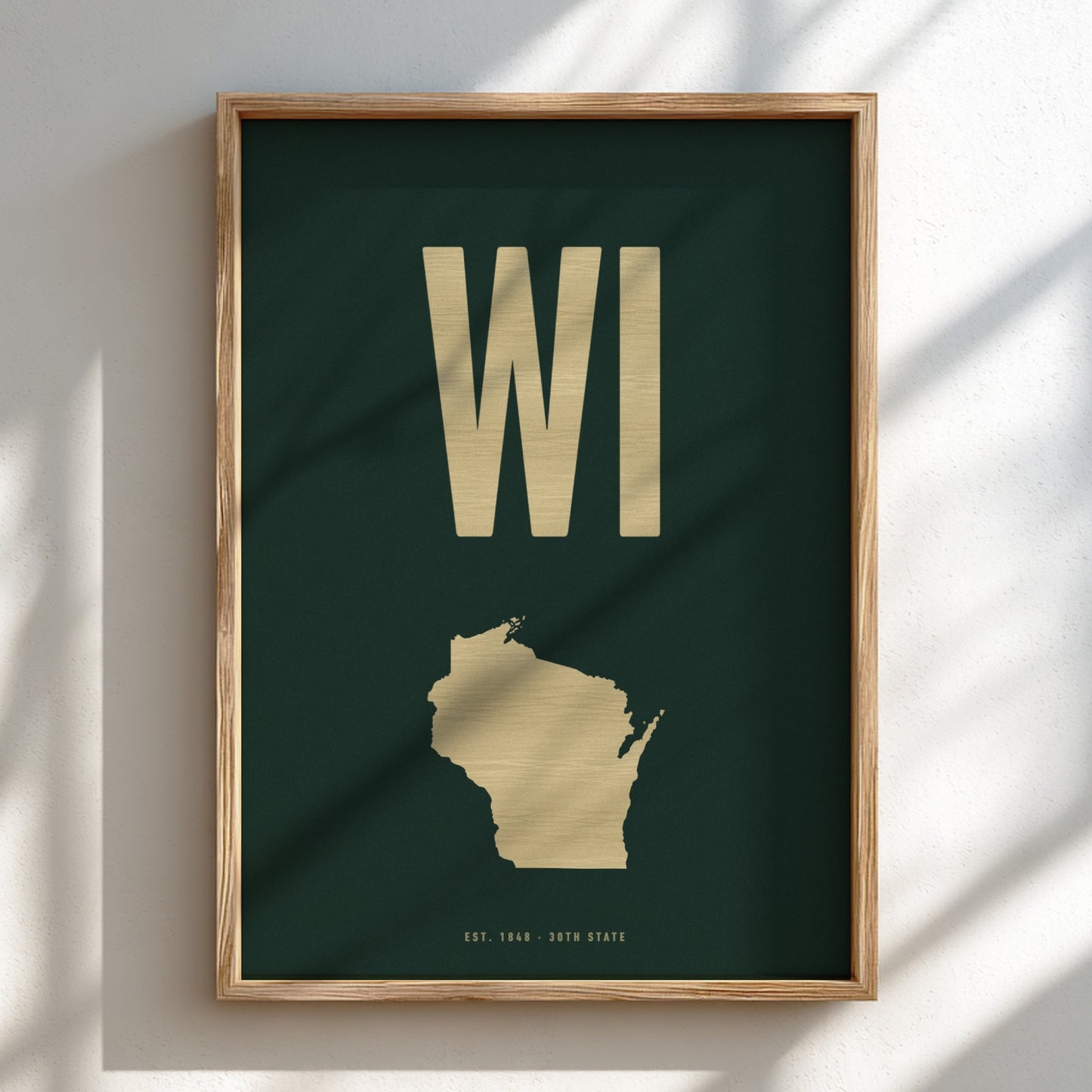 Framed poster with 'WI' and outline of Wisconsin on a dark green background
