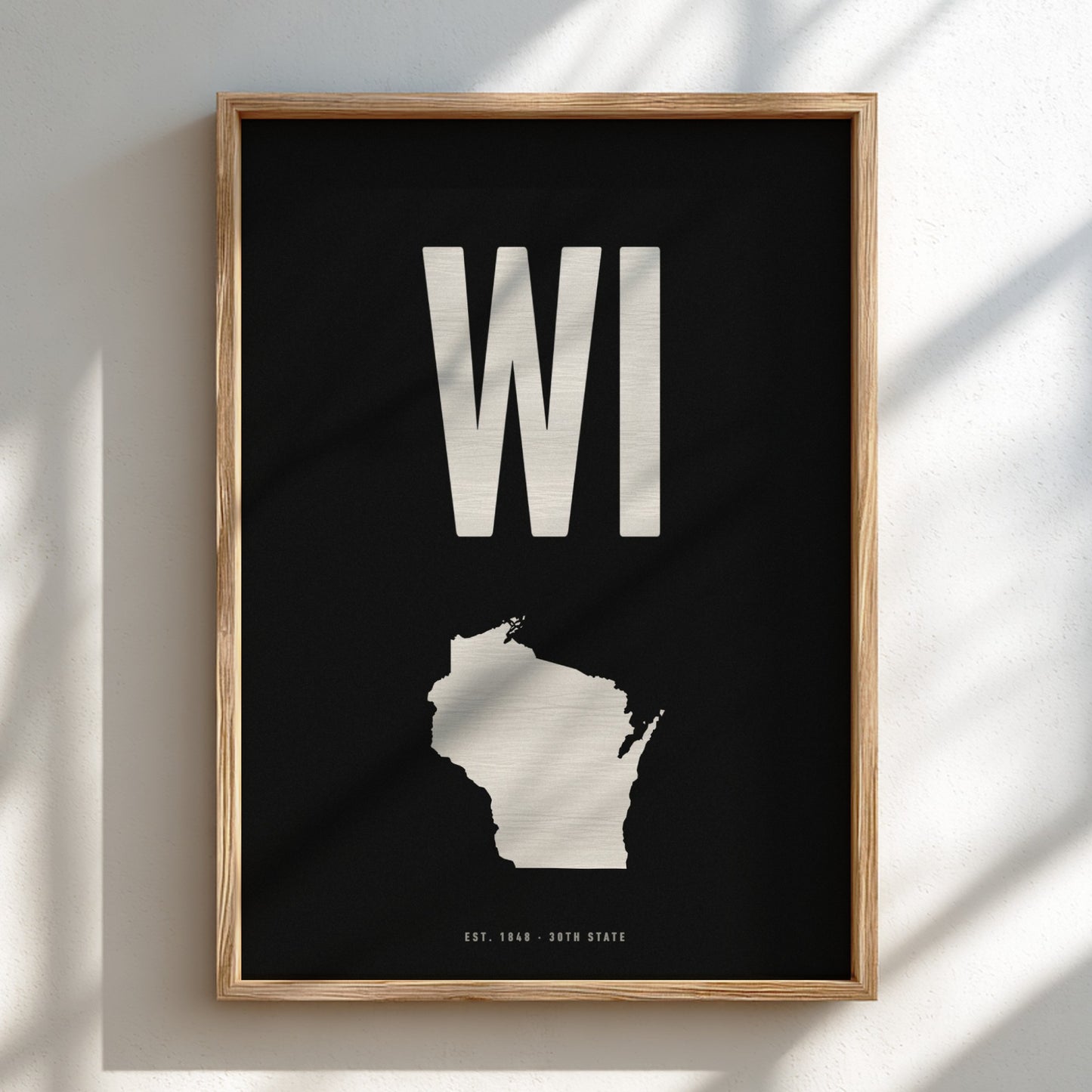 Framed poster of Wisconsin with 'WI' on a black background