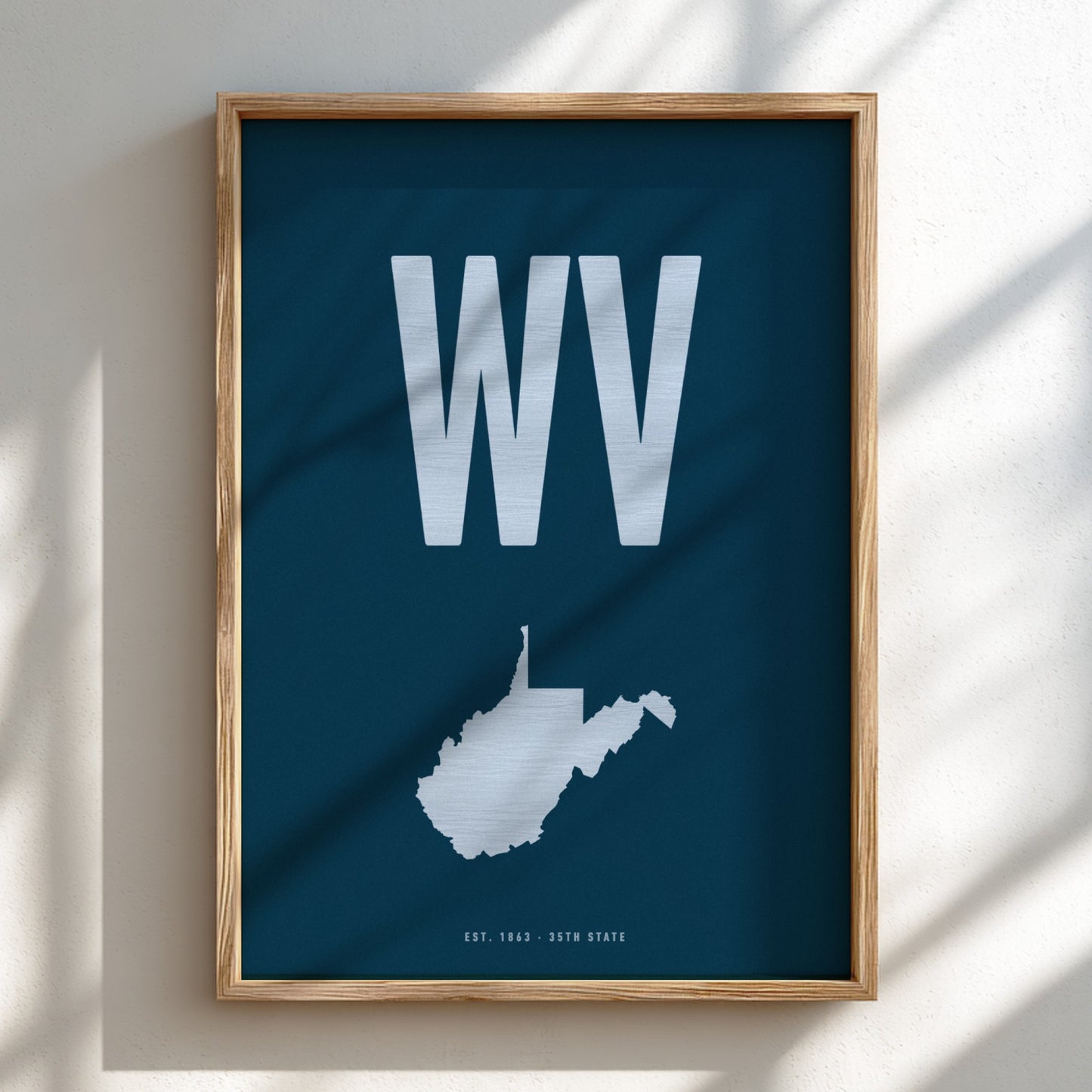 Framed poster with 'WV' and a map of West Virginia on a blue background