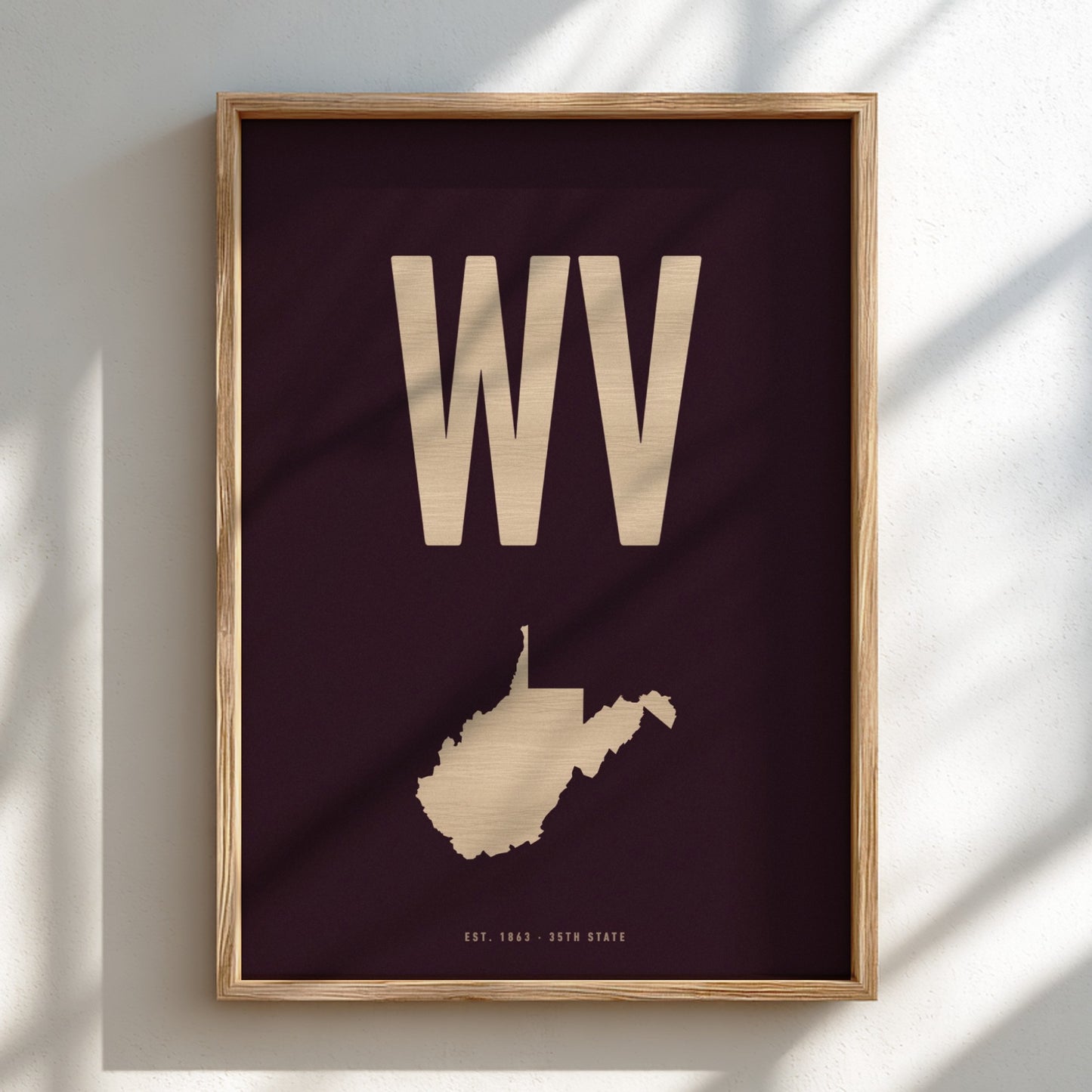 Framed artwork with 'WV' and a map of West Virginia on a dark background