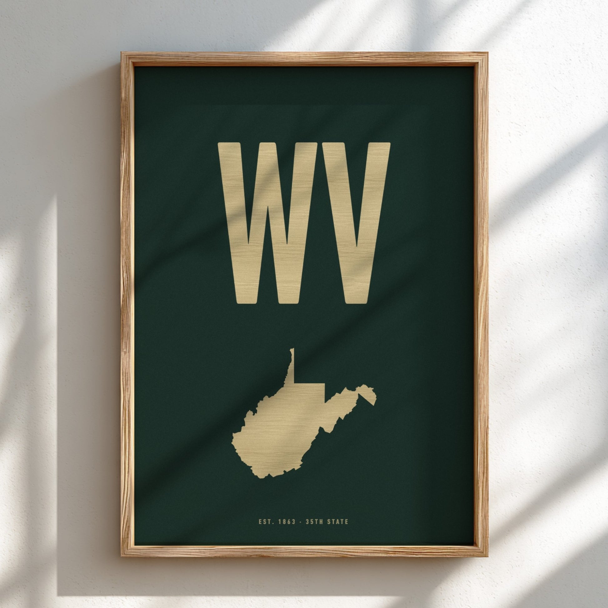 Framed artwork with 'WV' and a map of West Virginia on a dark green background