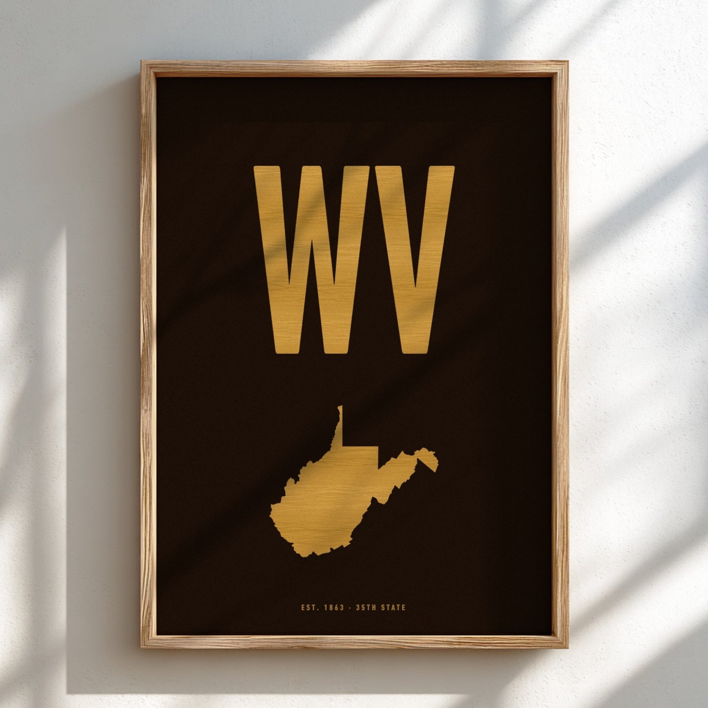 Framed artwork with 'WV' in gold on a dark background