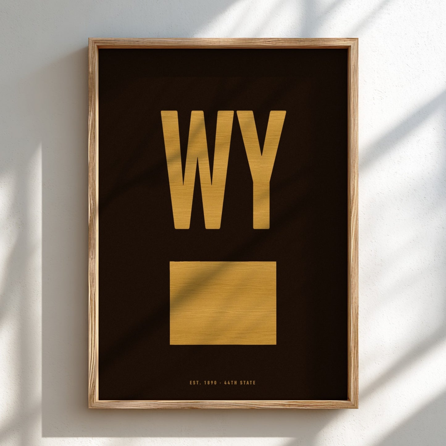 Framed artwork with 'WY' in gold on a black background