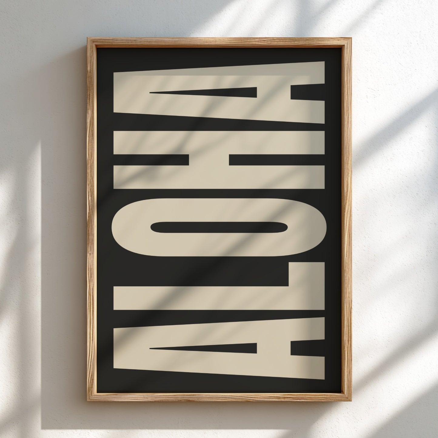 Framed artwork with 'ALOHA' text on a black background