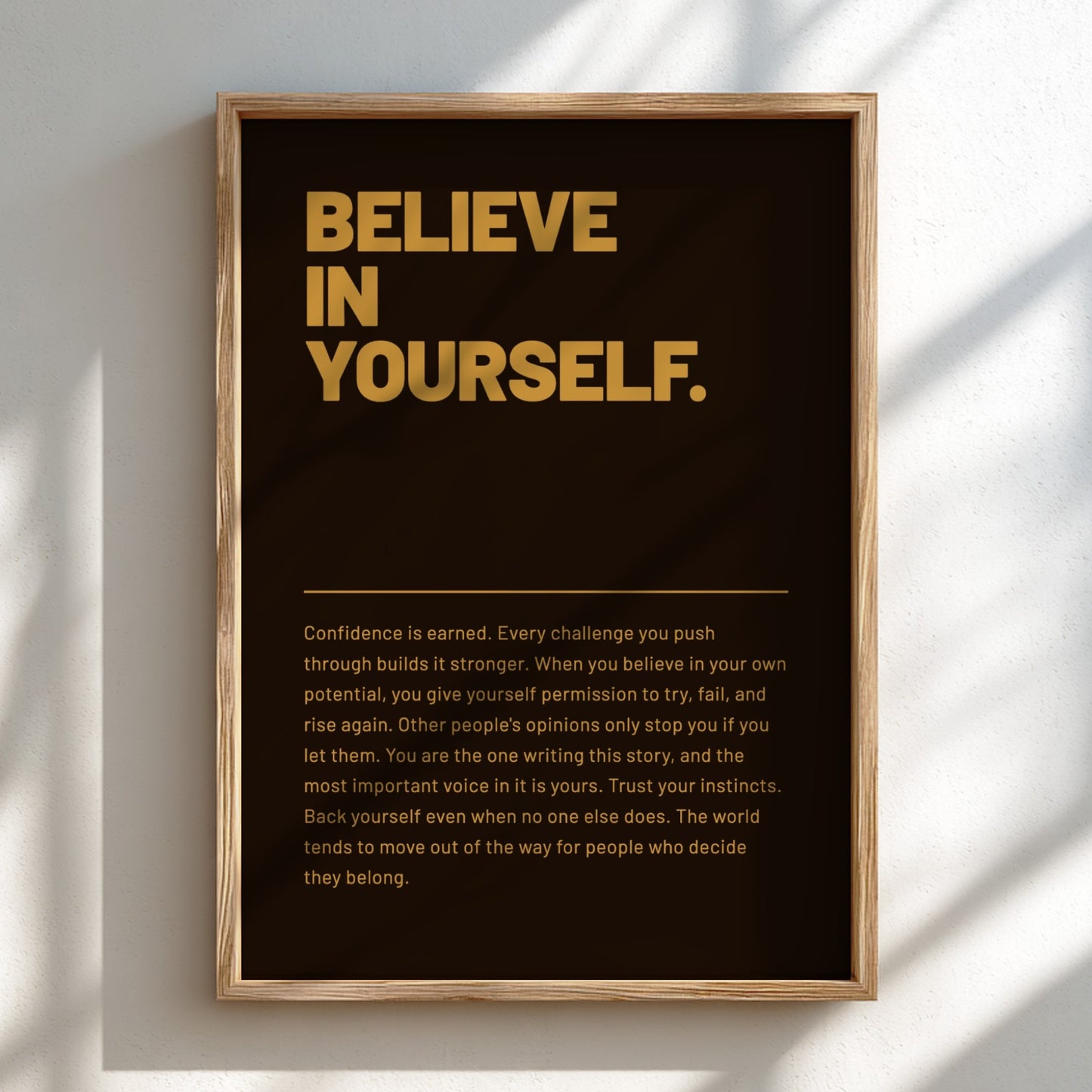 Framed poster with 'BELIEVE IN YOURSELF' text on a dark background
