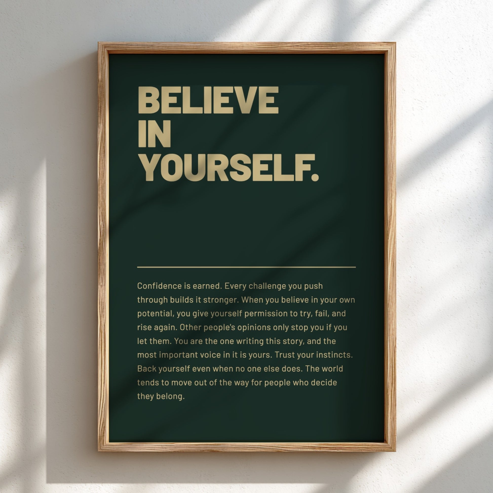Framed poster with motivational quote 'Believe in Yourself' on a dark green background